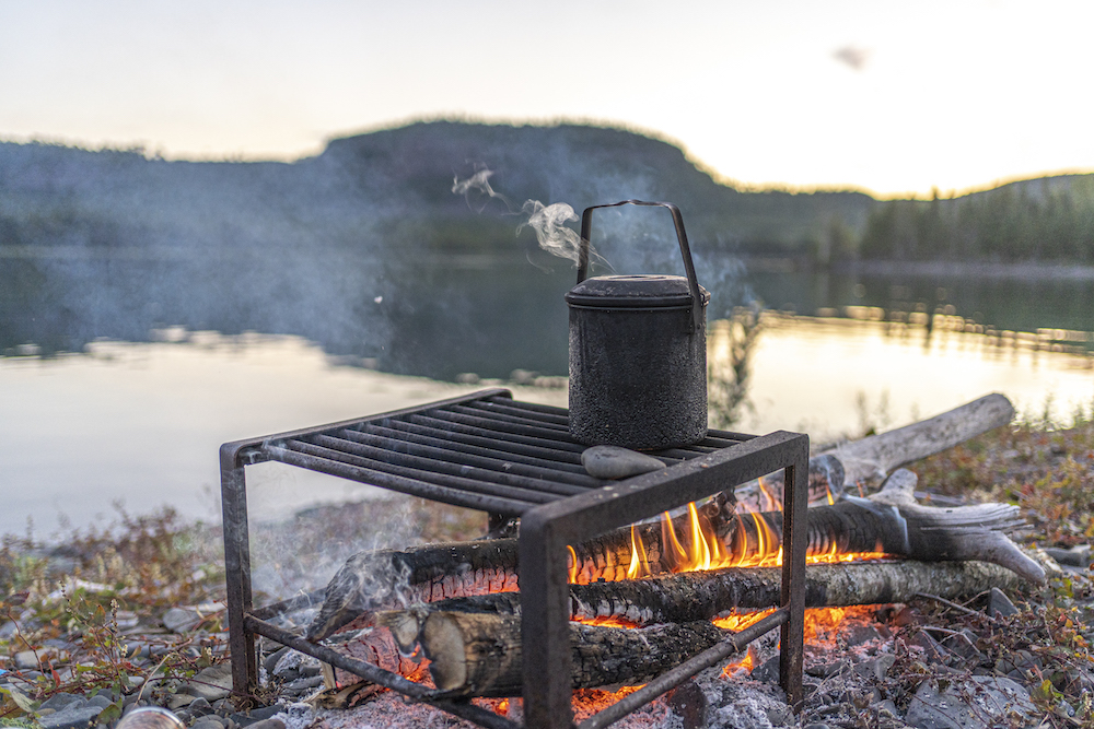 Kettle boiling over campfire