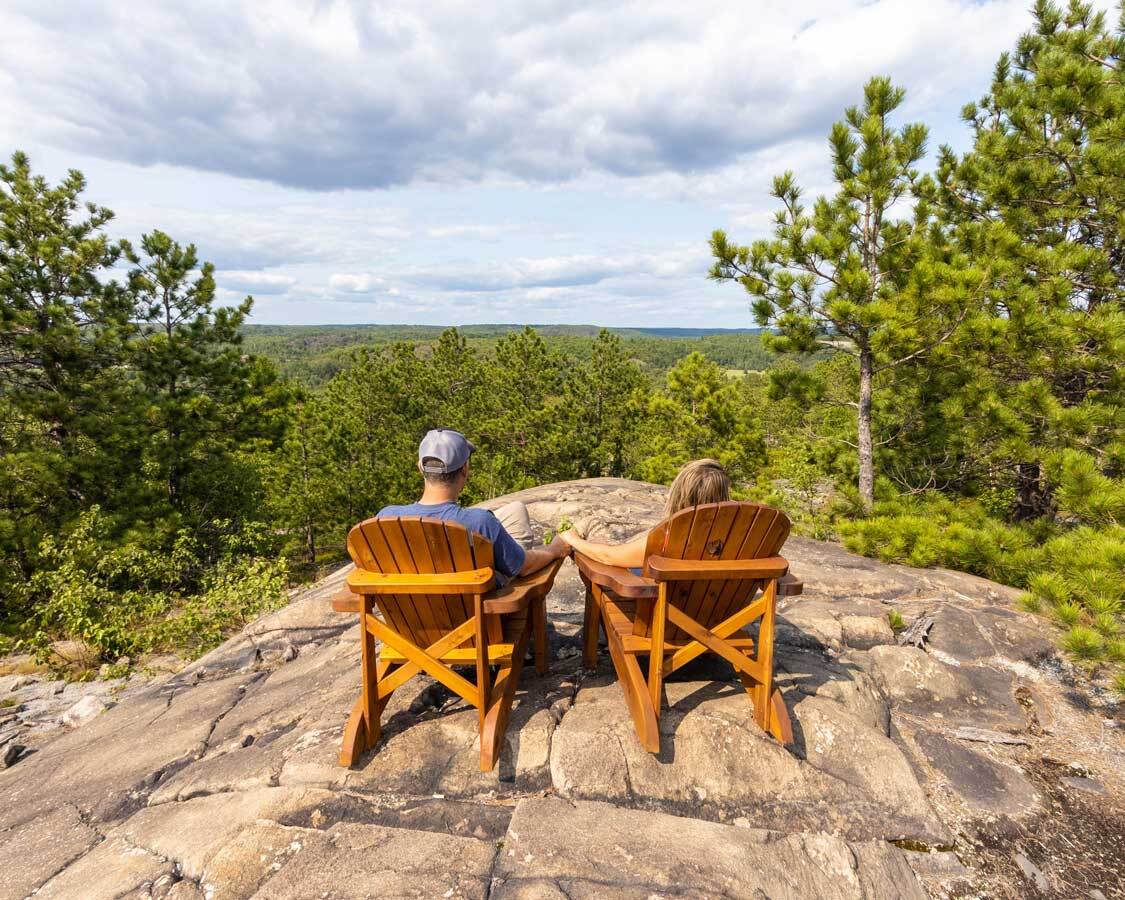 two people sitting in chairs at vast lookout
