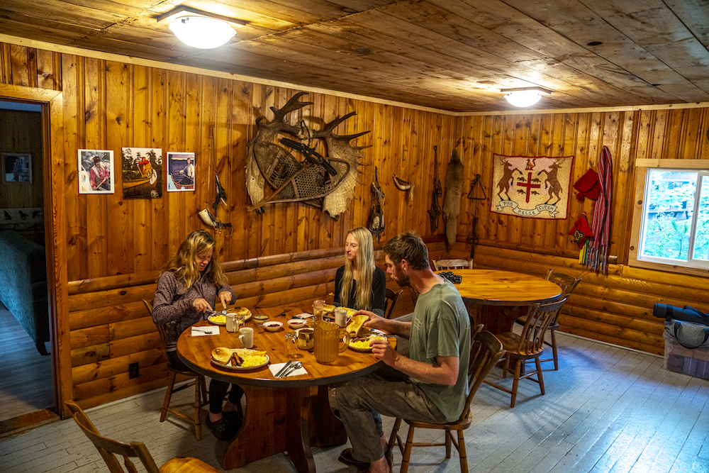 Three people dining in log restaurant.