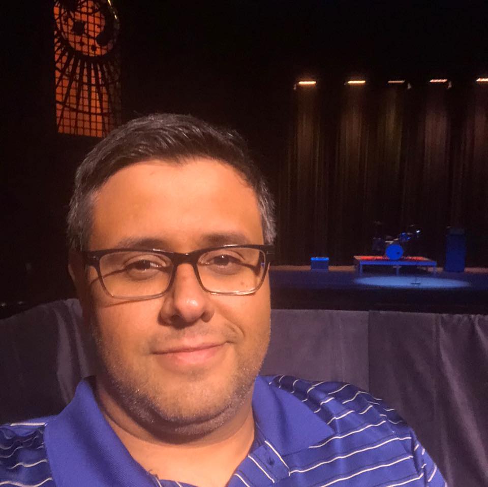 headshot of Dan Misturada, smiling in front of a dark background