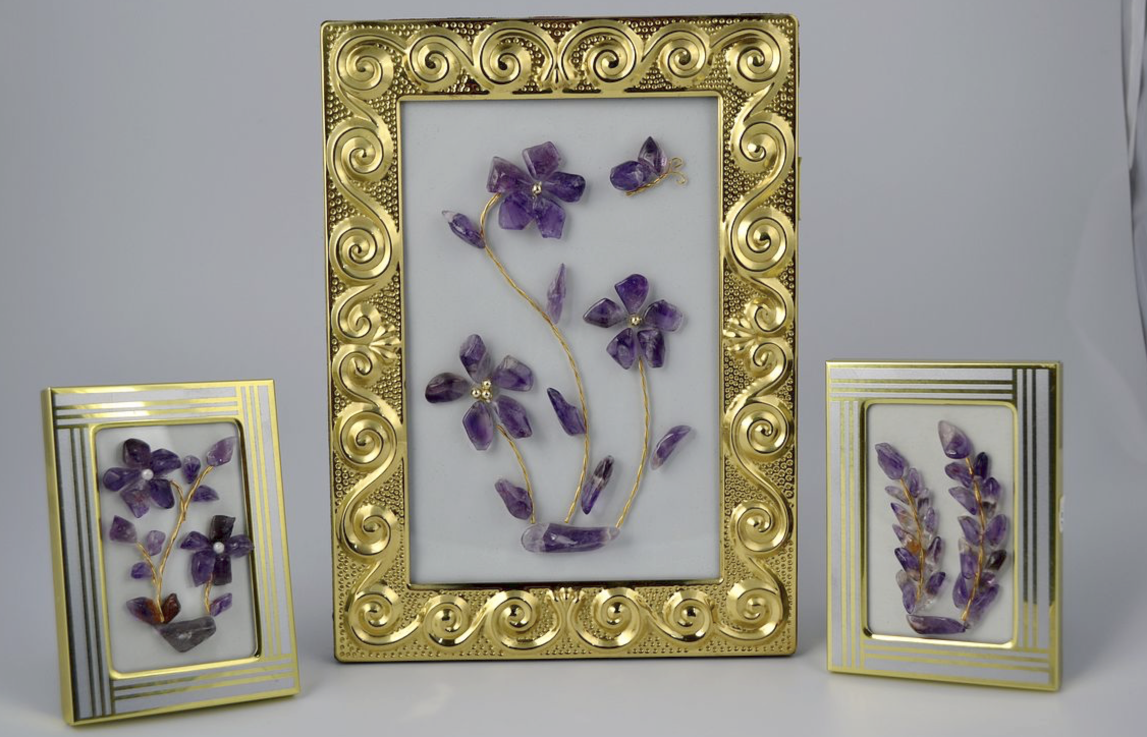 3 framed pictures made out of amethyst stones arranged into elegant floral motifs