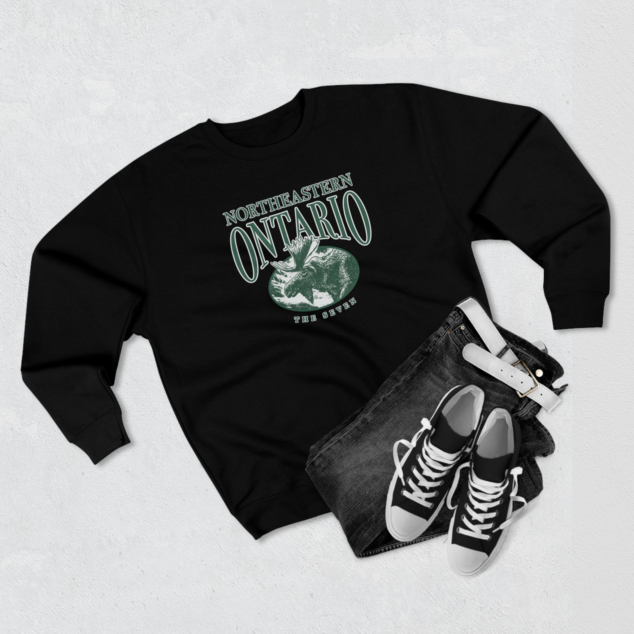 a black crewneck sweater with a logo of a moose and "Northerneastern Ontario — The Seven" on the front