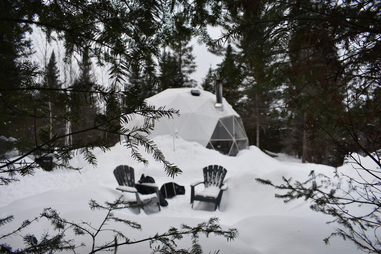 snowy glamping dome in the forest