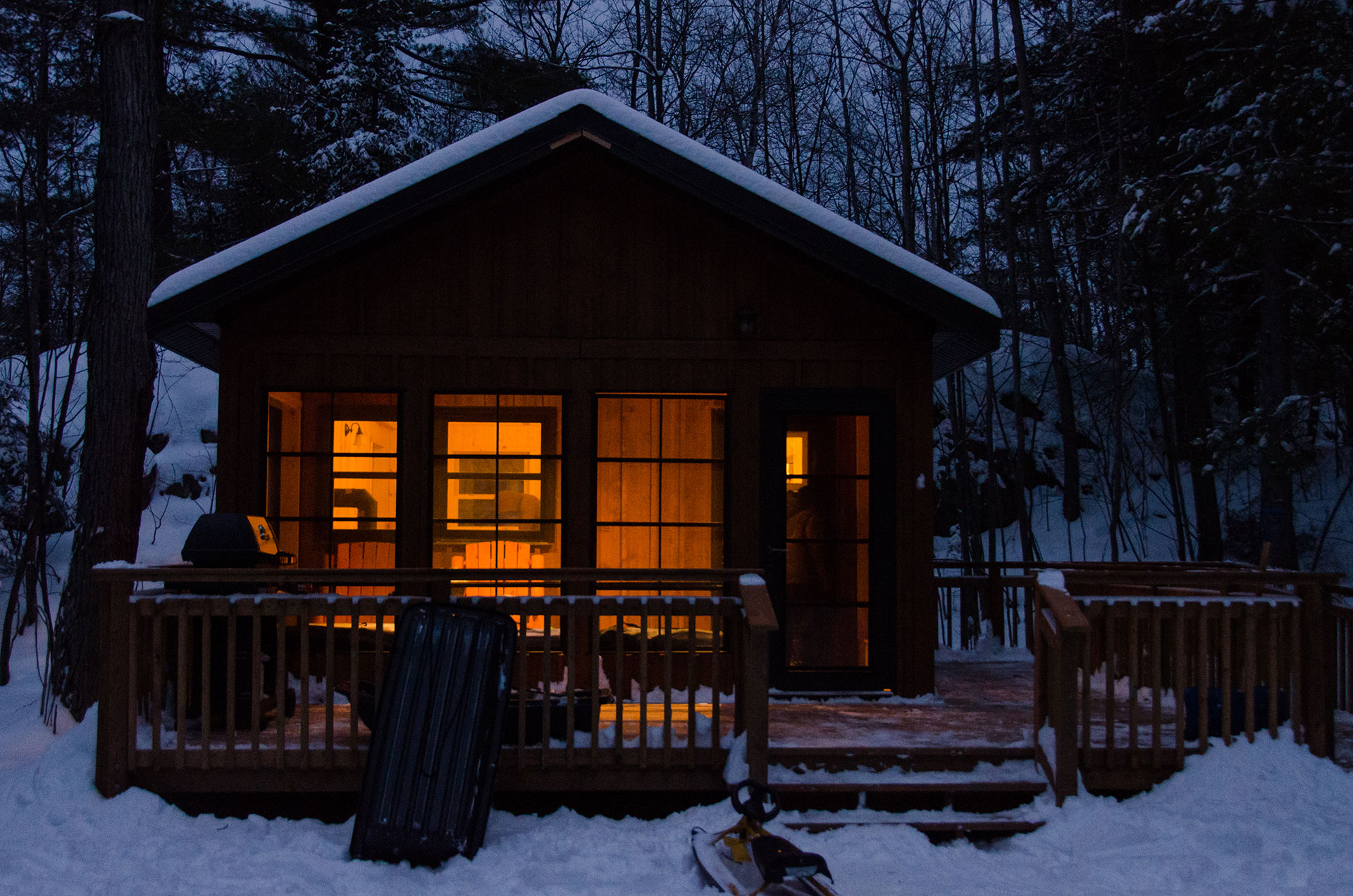 cozy winter cabin at dusk in Killarney Provincial Park