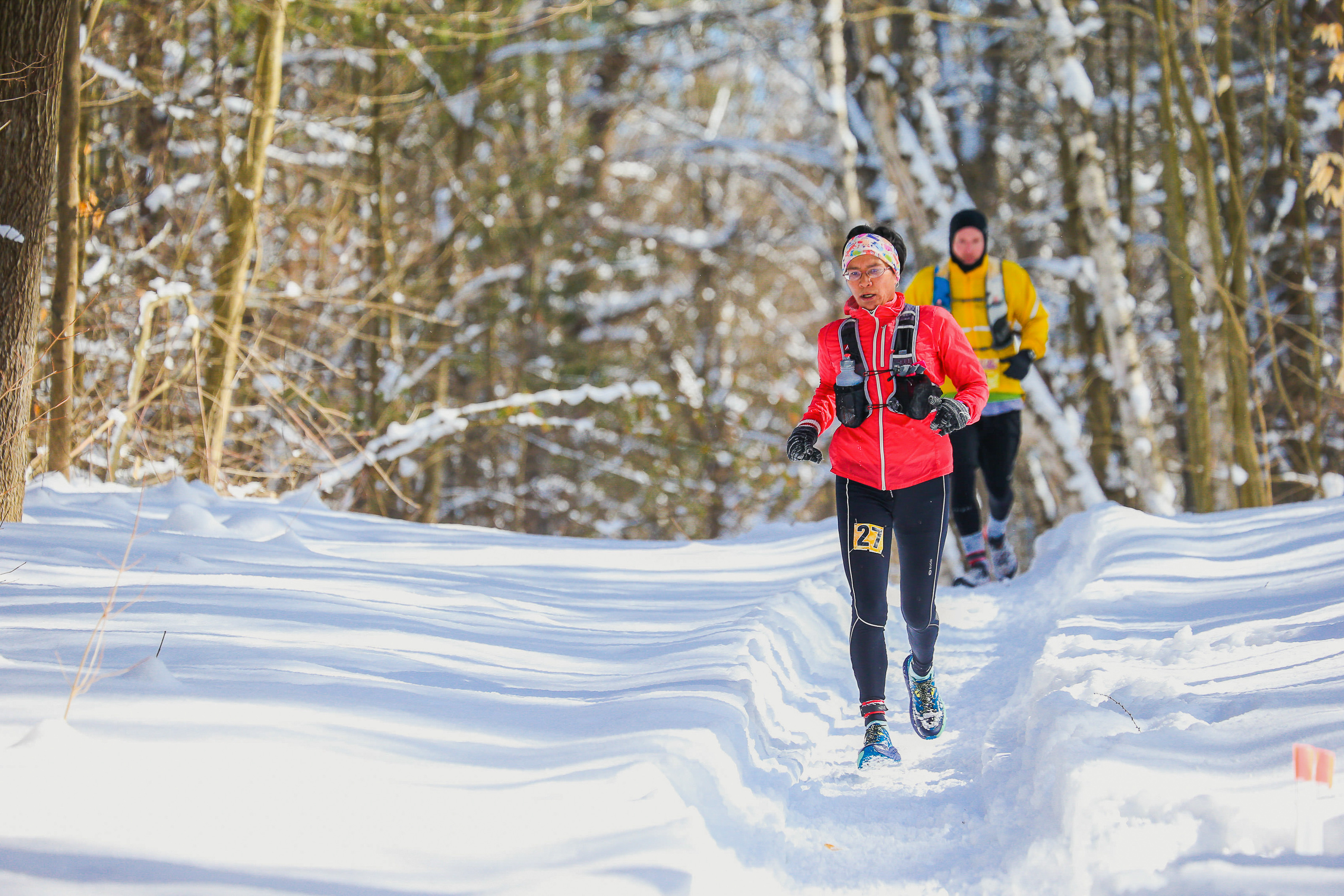 two people trail running in winter