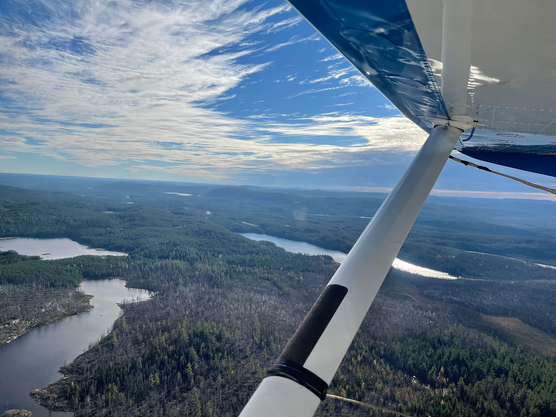 a plane flies over Lady Evelyn Smoothwater Provincial Park