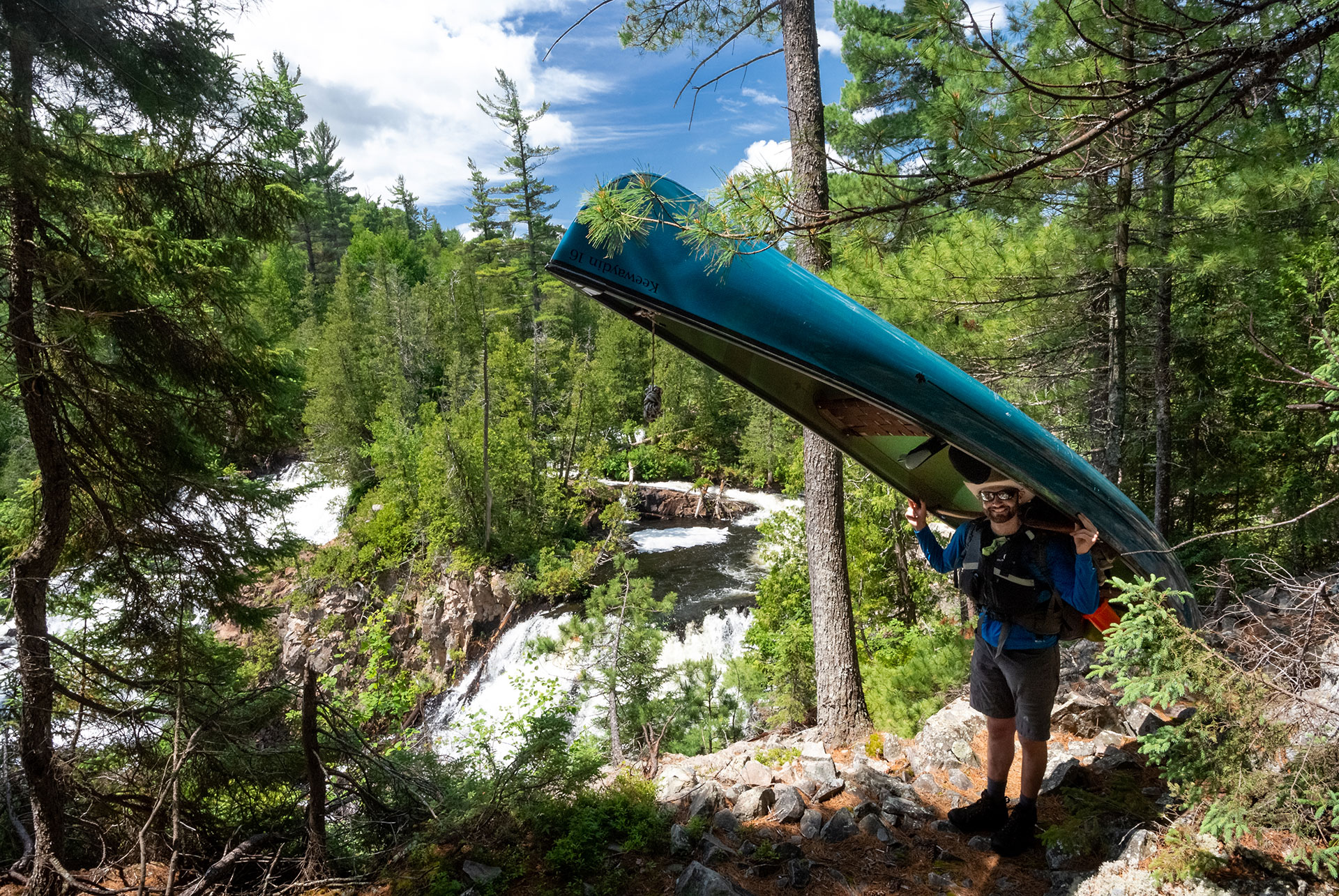 man poses while portaging a canoe at Lady Evelyn Smoothwater Provincial Park