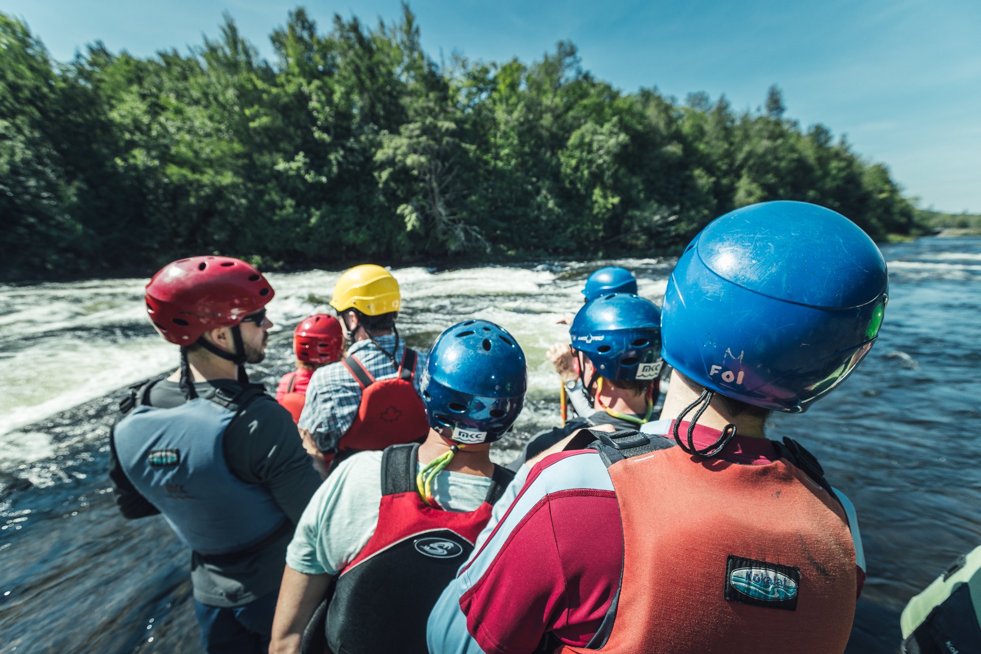 people participate in a whitewater paddling course on the Madawaska River