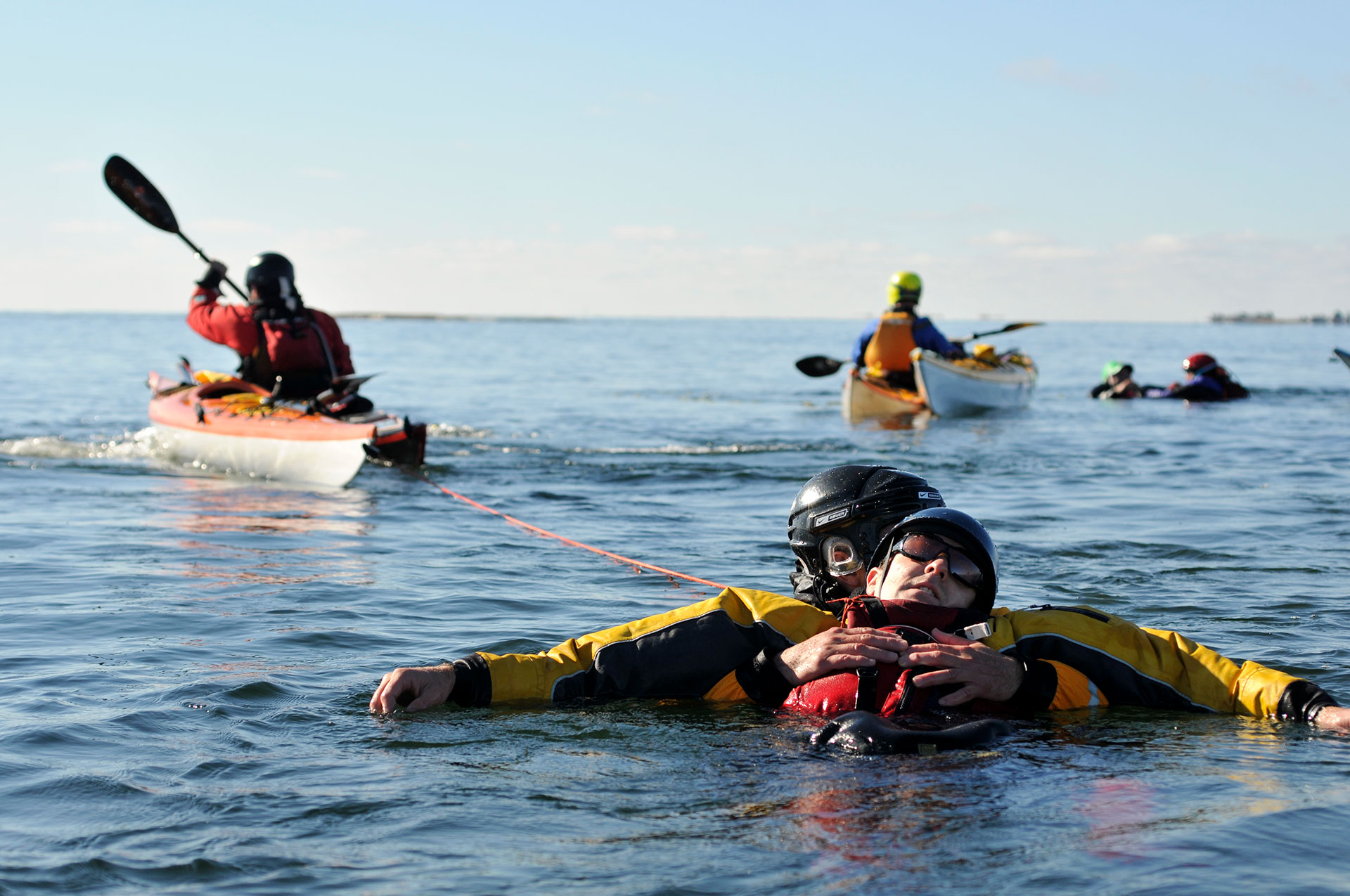people practicing kayak rescue