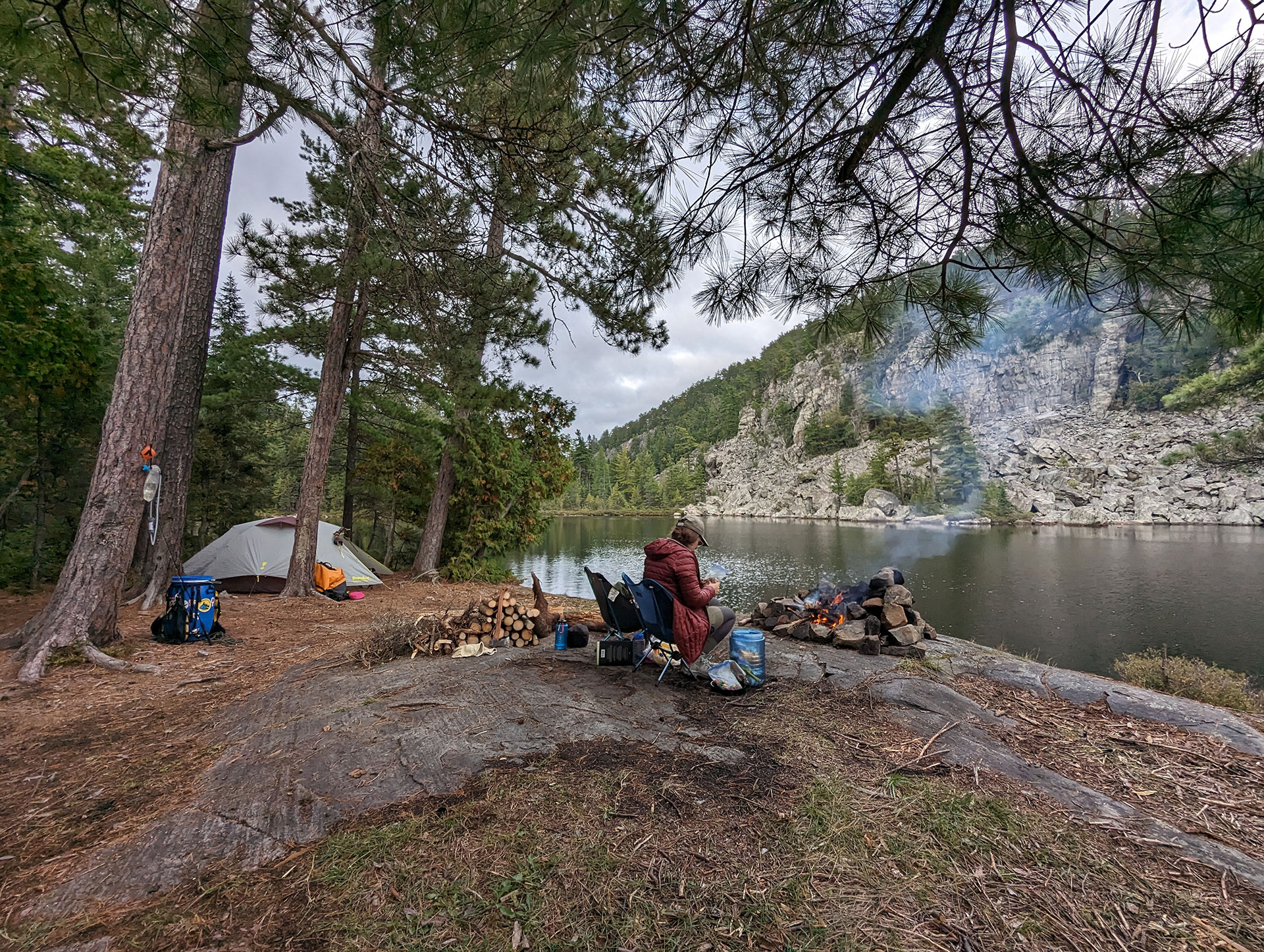 person sits at a campsite in Obabika River Provincial Park