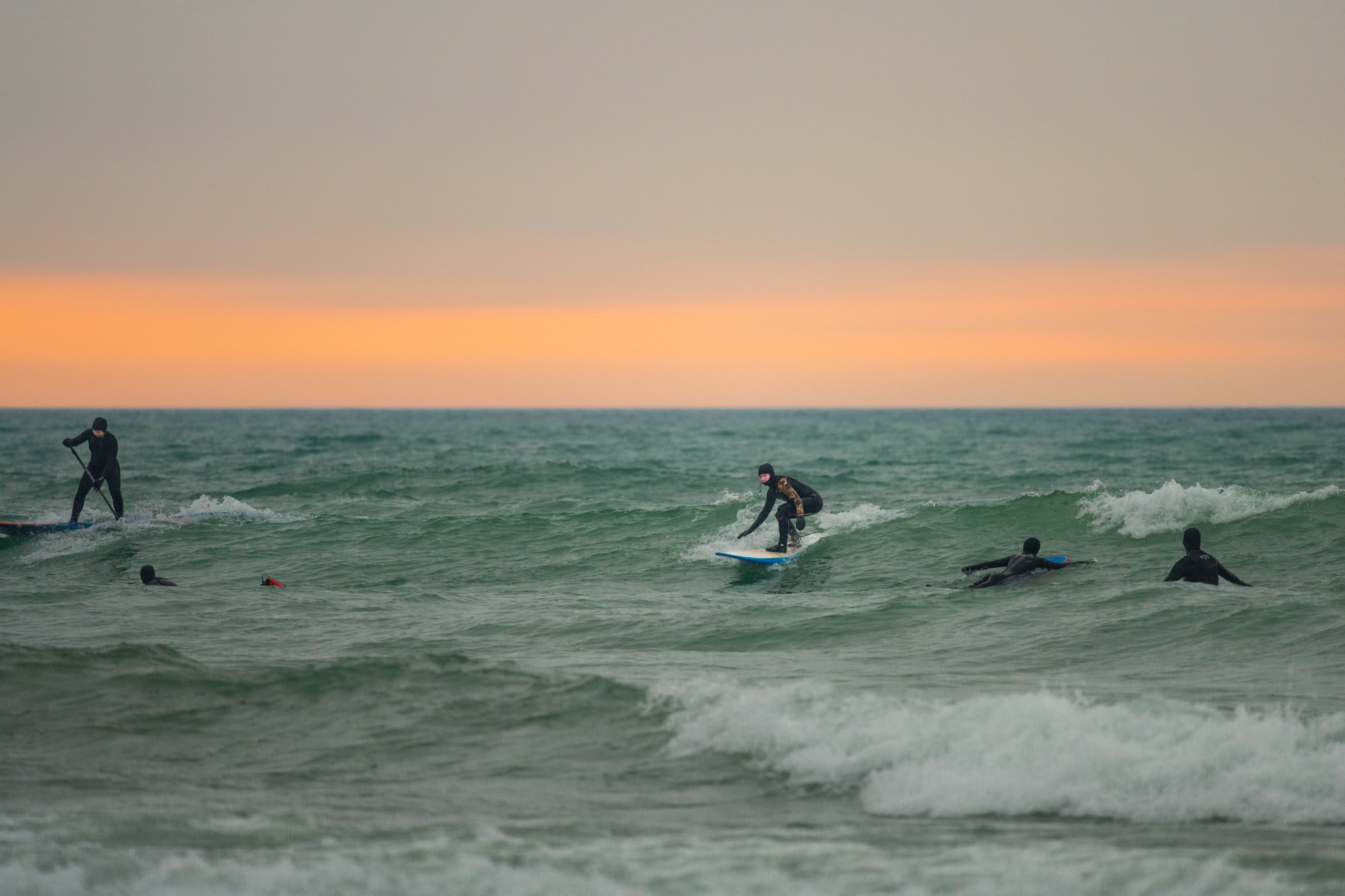 people SUP surfing on Lake Ontario