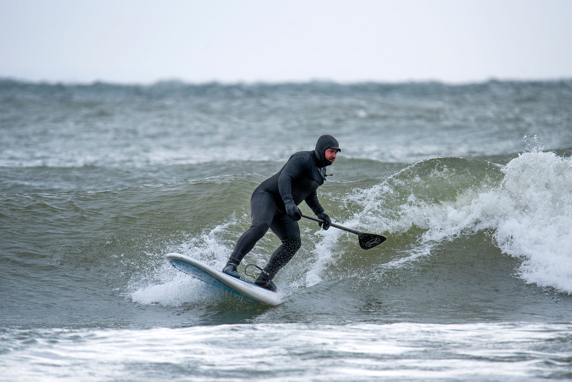 a man SUP surfing at Pancake Bay