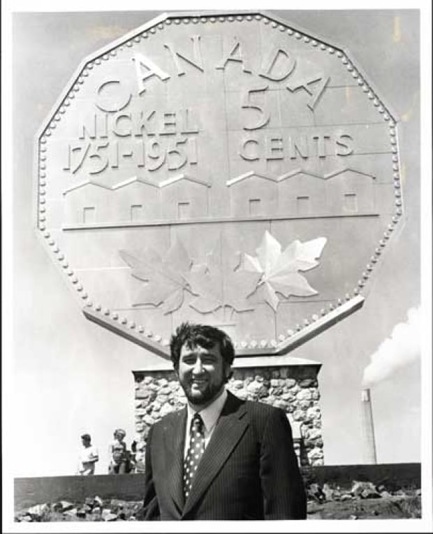 a black and white photograph of Ted Szilva in front of the Big Nickel
