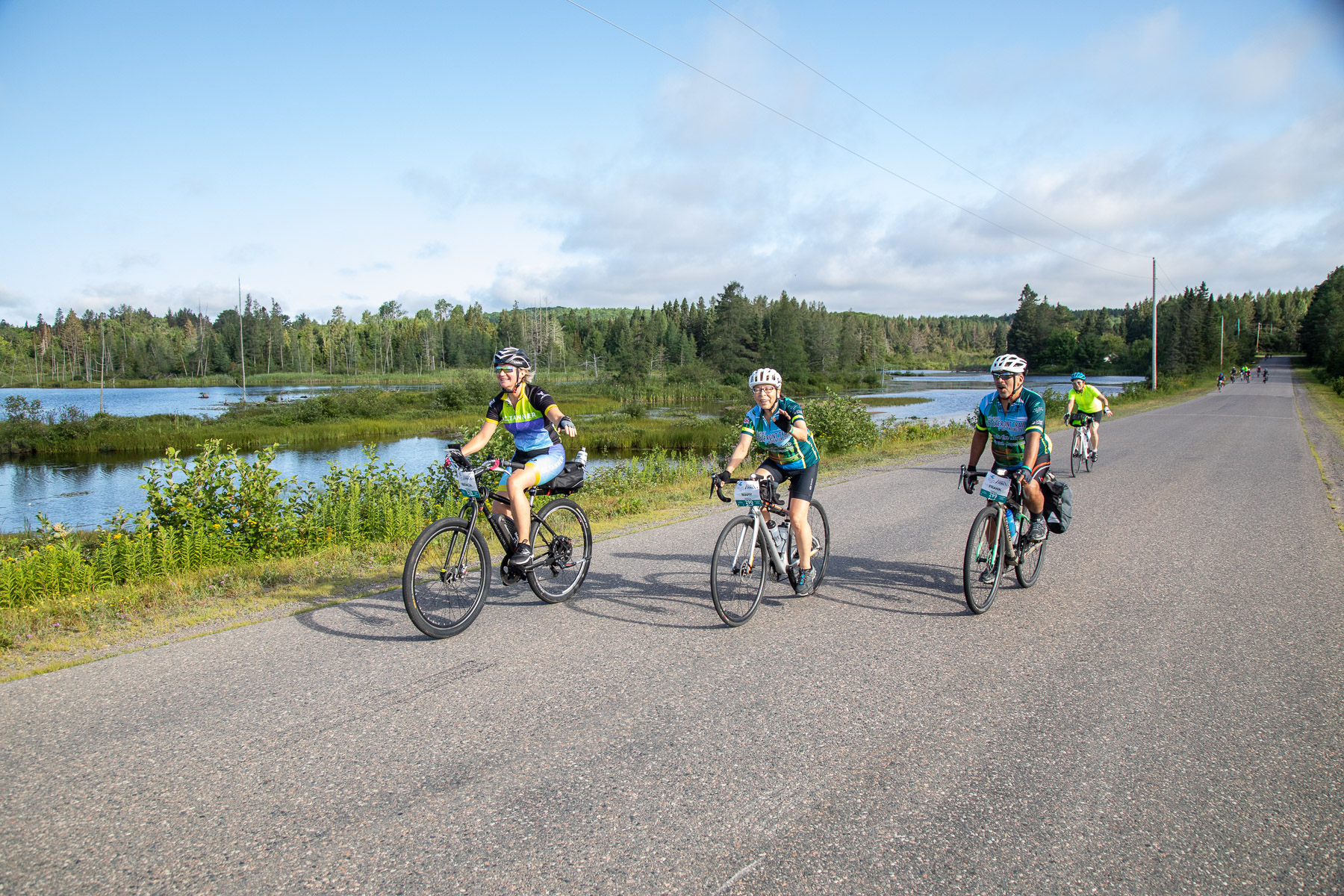 three cyclists ride along the Great Lakes Waterfront Trail