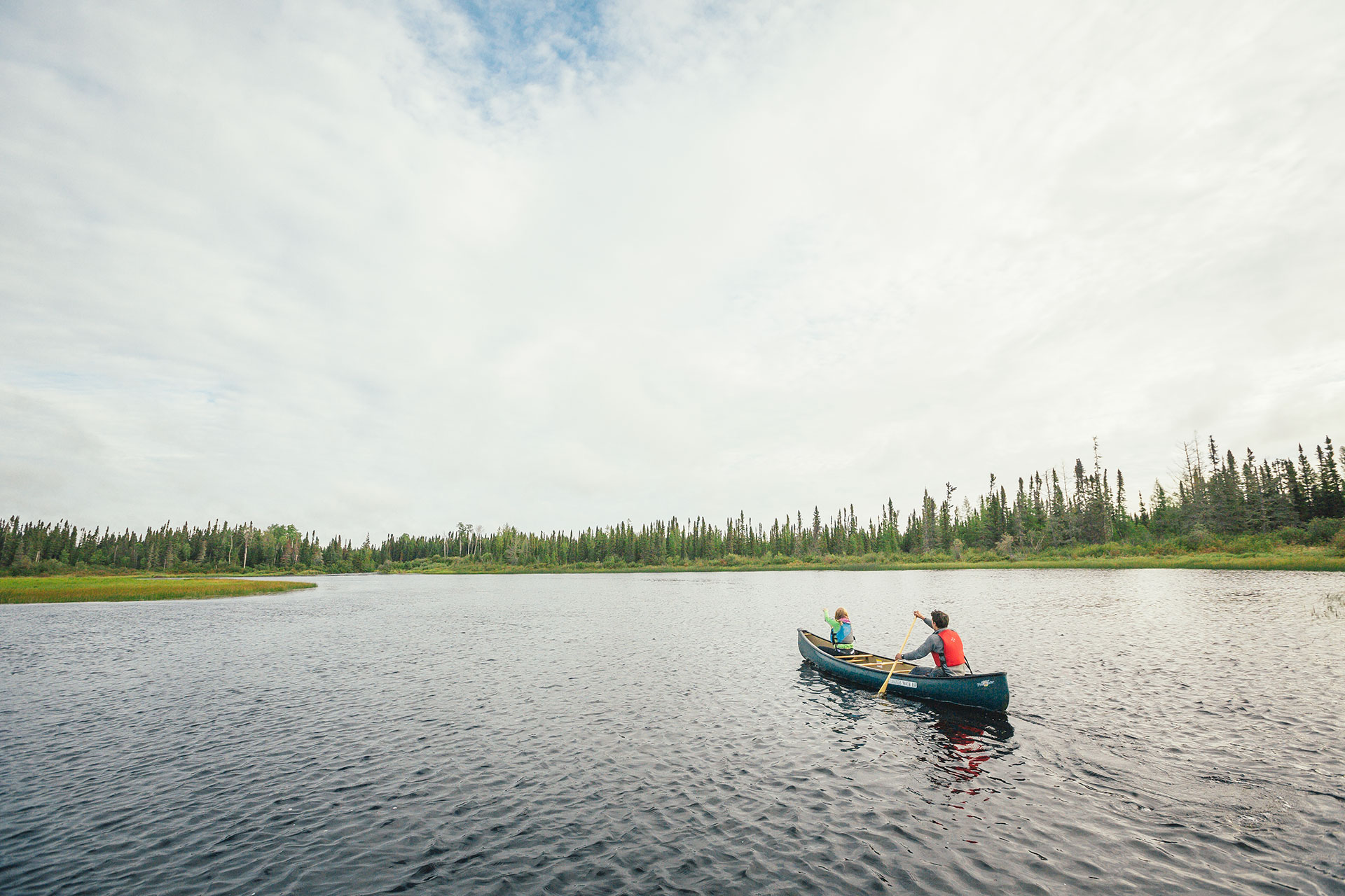 people paddling a canoe in Wabakimi