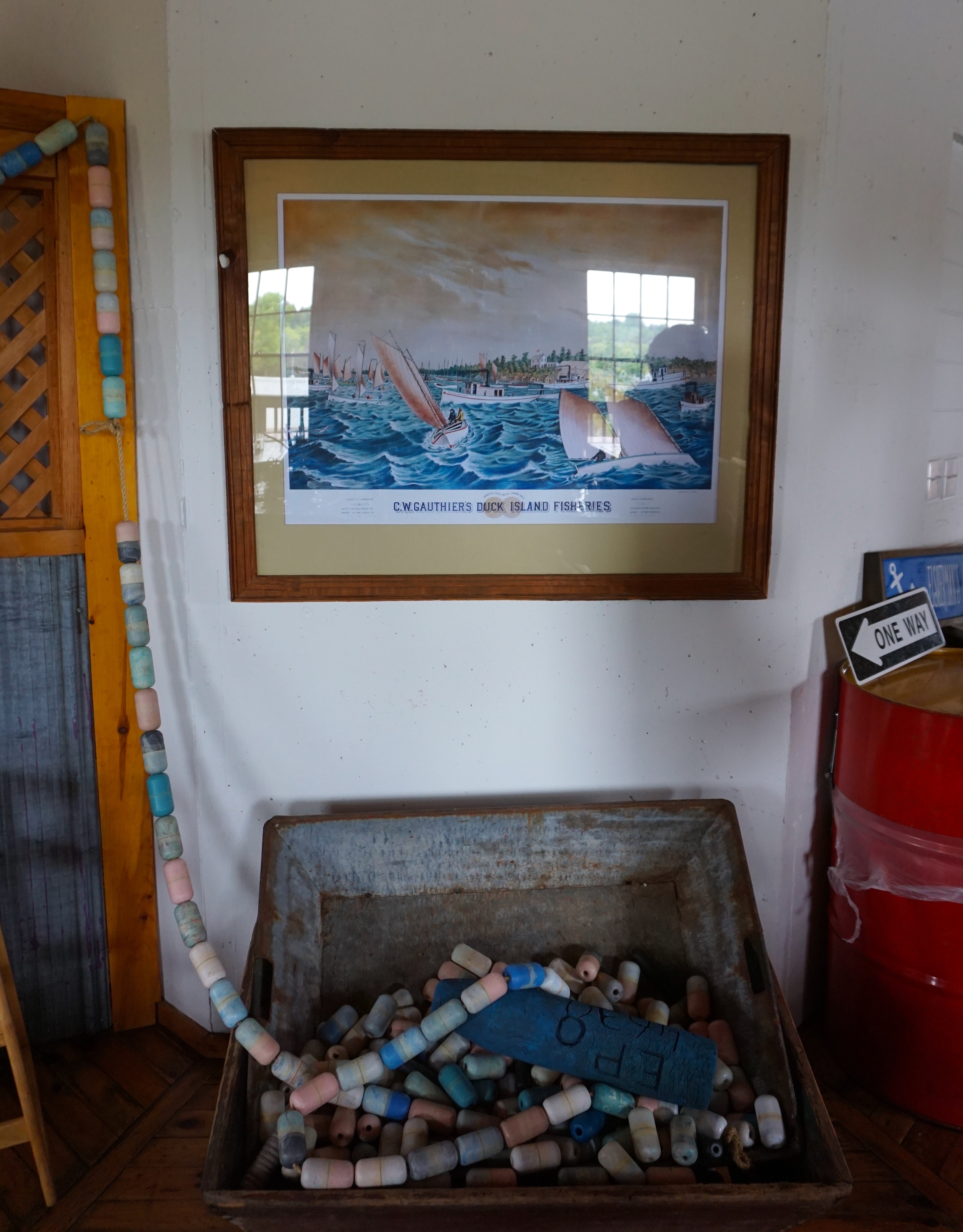 a painting at Purvis Fish & Chips of a harbour, along with some signs and seafaring artifacts