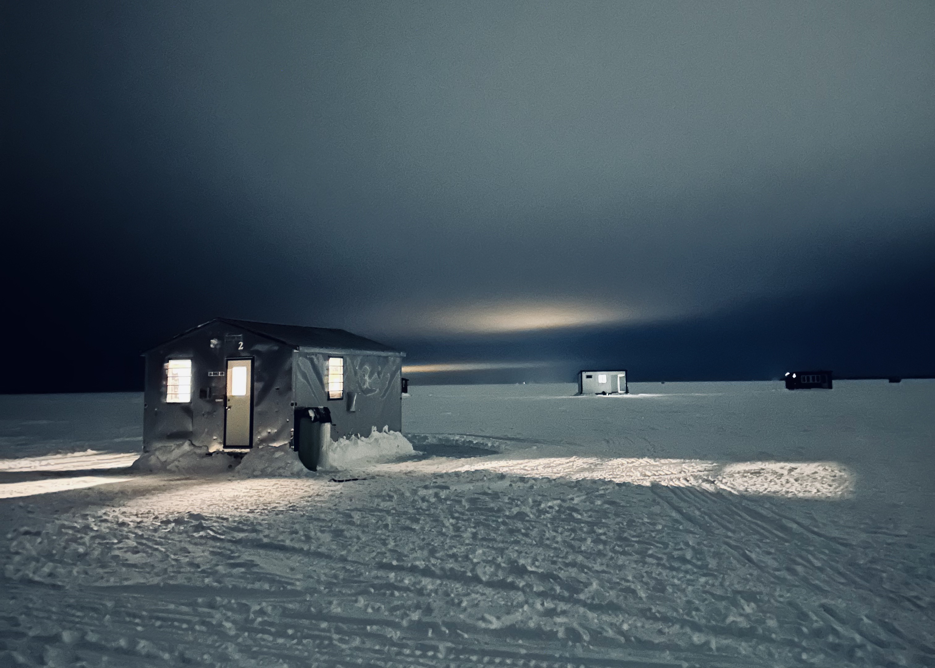 Bam's bungalows illuminated on the ice at night