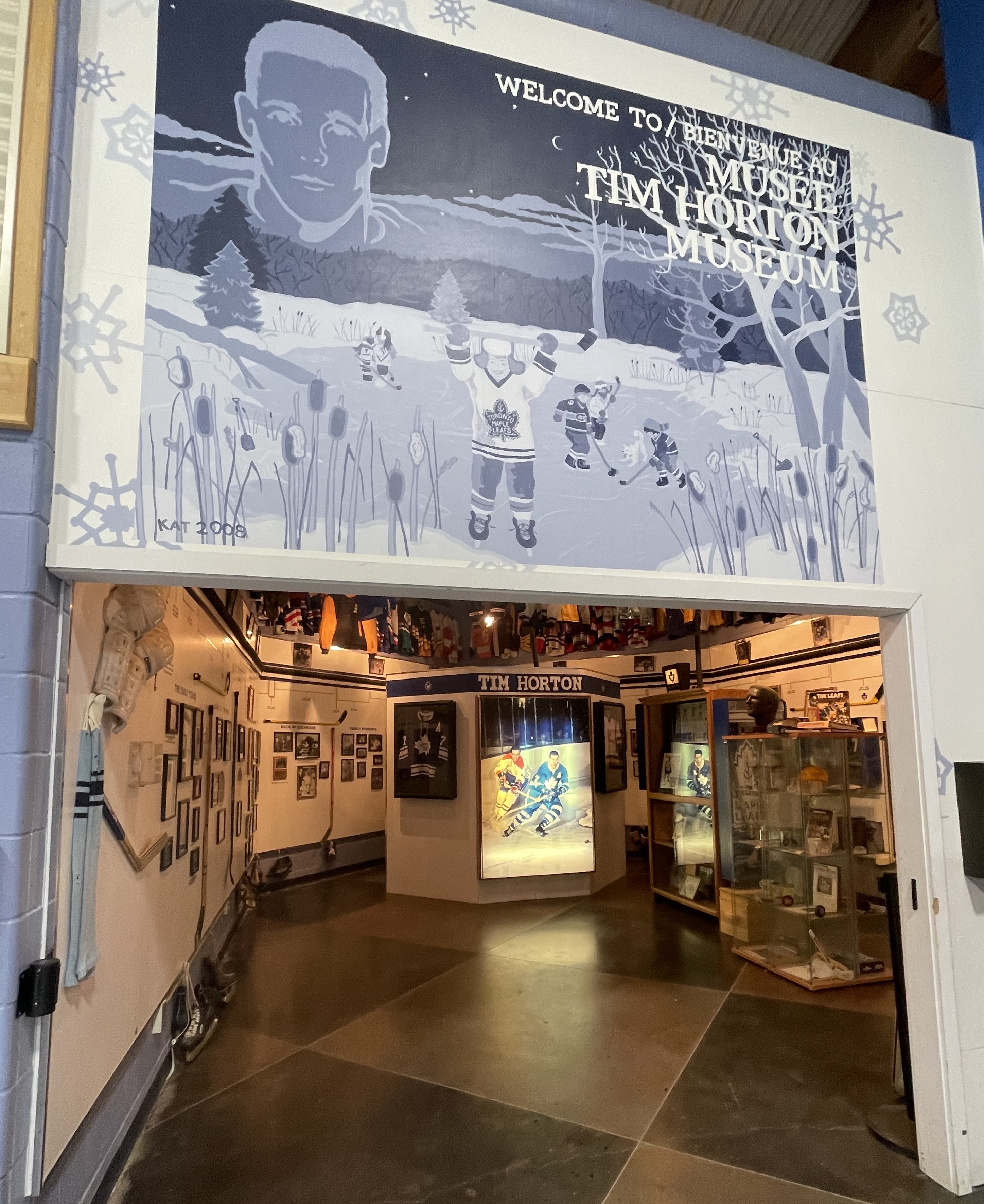 The entrance to the Tim Horton Museum, with a large sign overhead featuring graphics of the hockey player and the words "Welcome to the Tim Horton Museum".