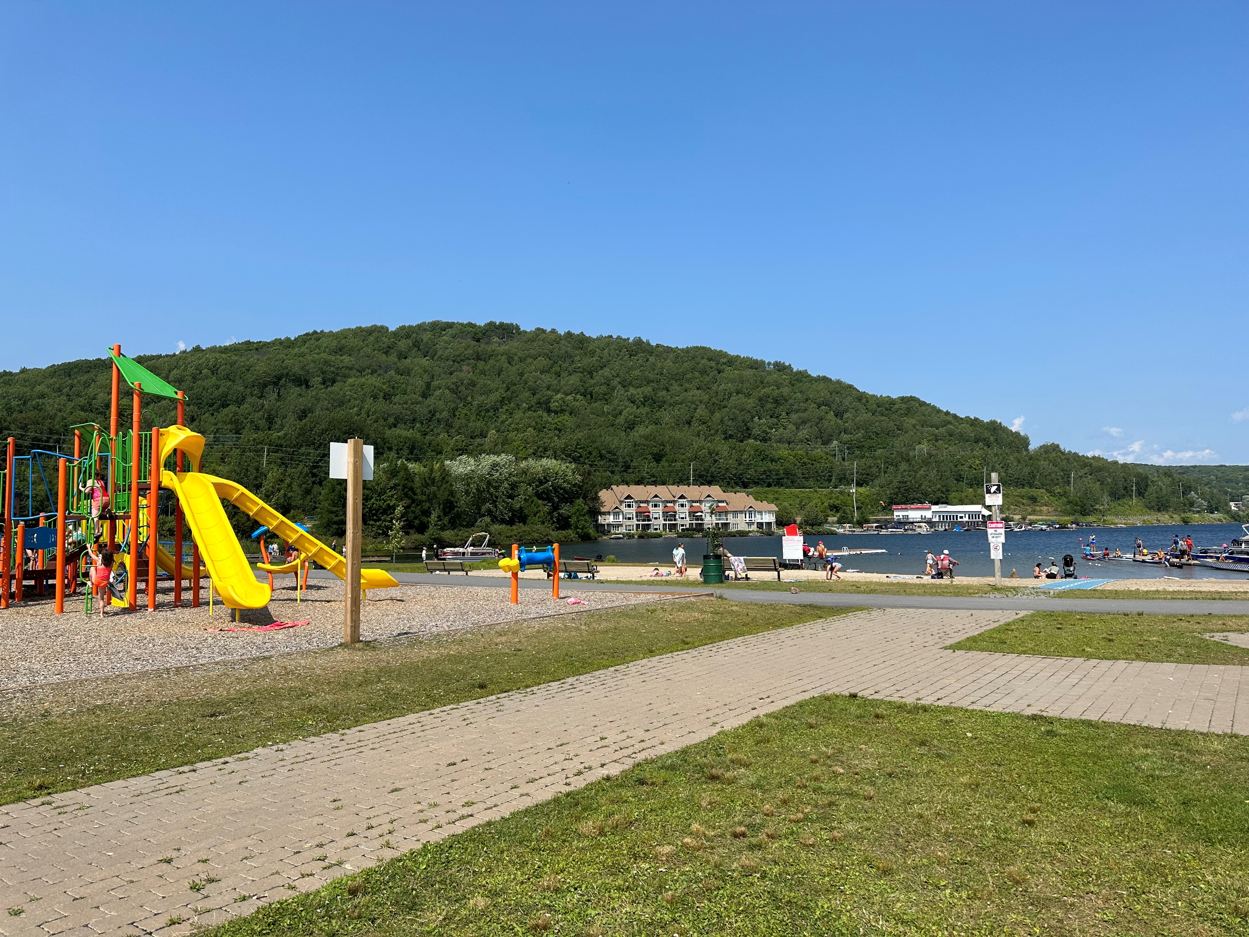 Olmstead Beach with a playground near a lake. 