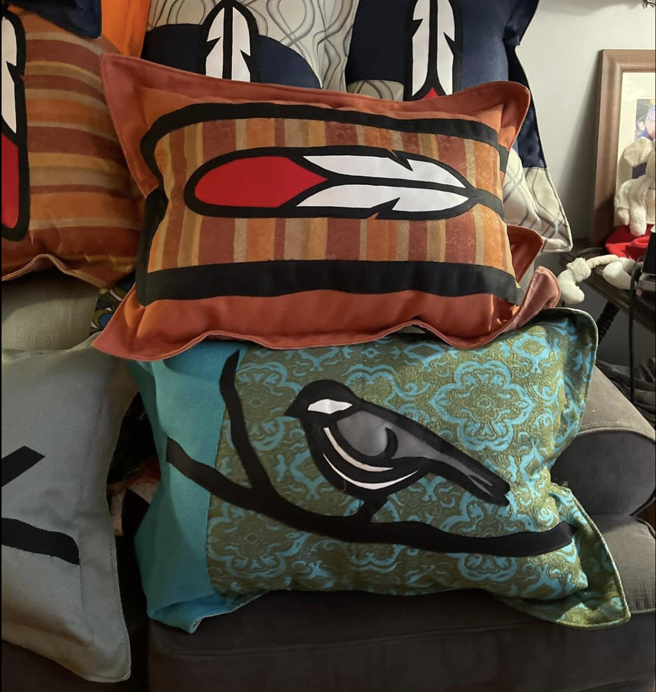 A series of colourful quilted pillows with beautiful chickadee and feather designs.