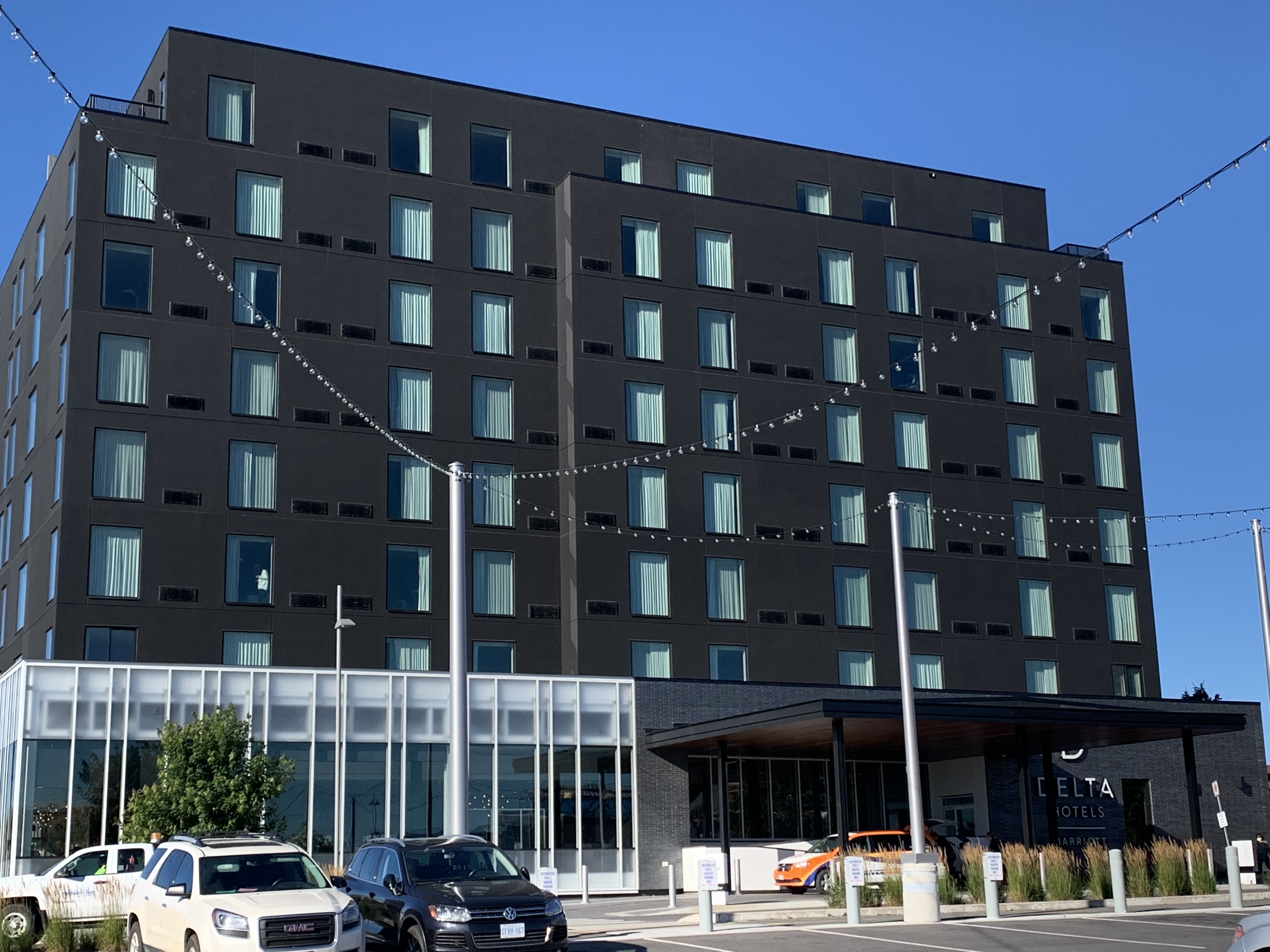 The Delta Marriott, Thunder Bay; a large, stately multi-storey black building with a covered glass walkway at the front.