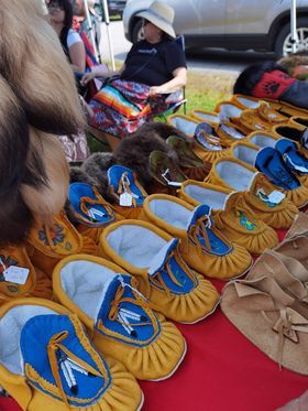 finely crafted moccassins laid on a vendor's table at a pow wow near North Bay.