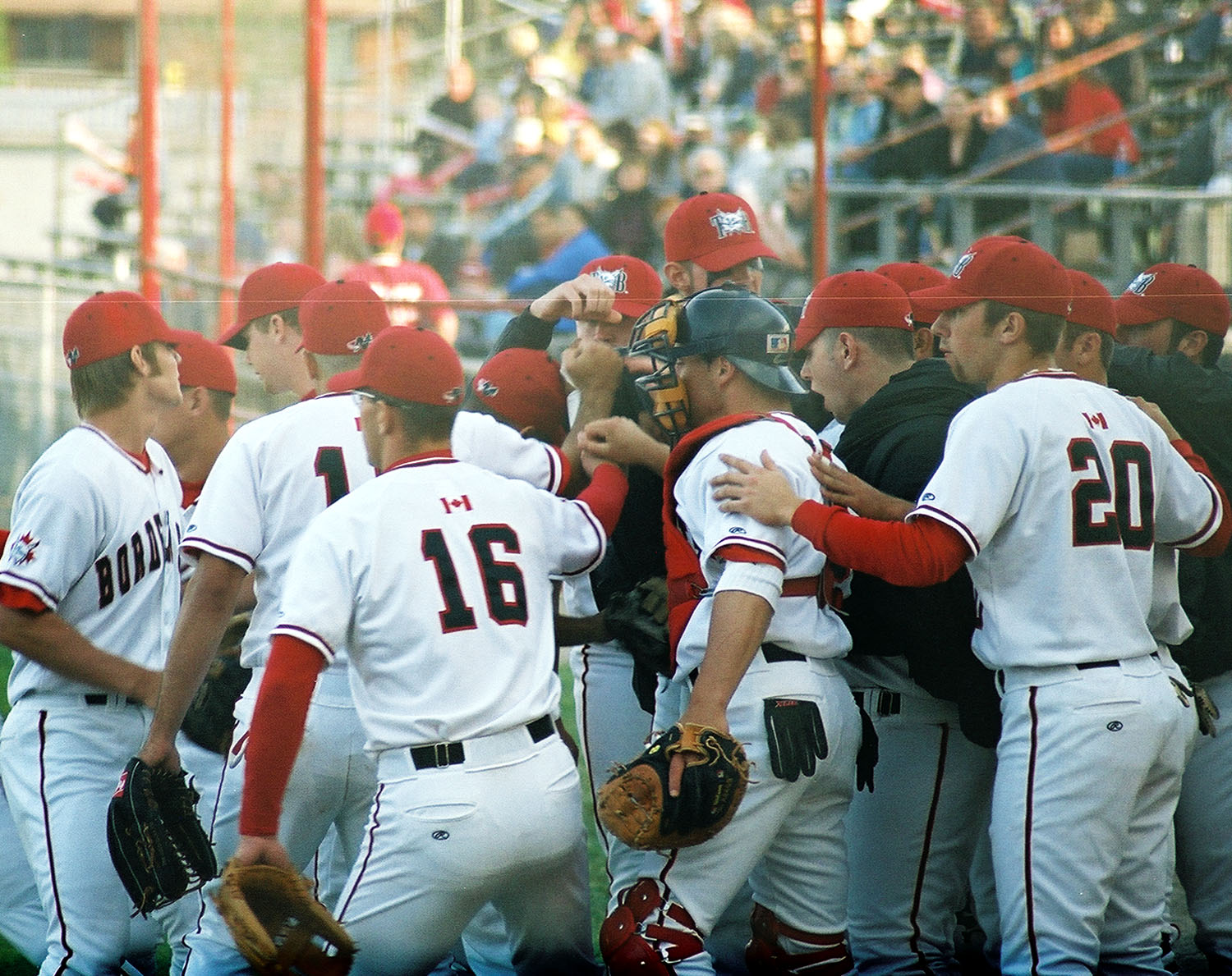 The Bordercats grouped together congratulating each other after a play.