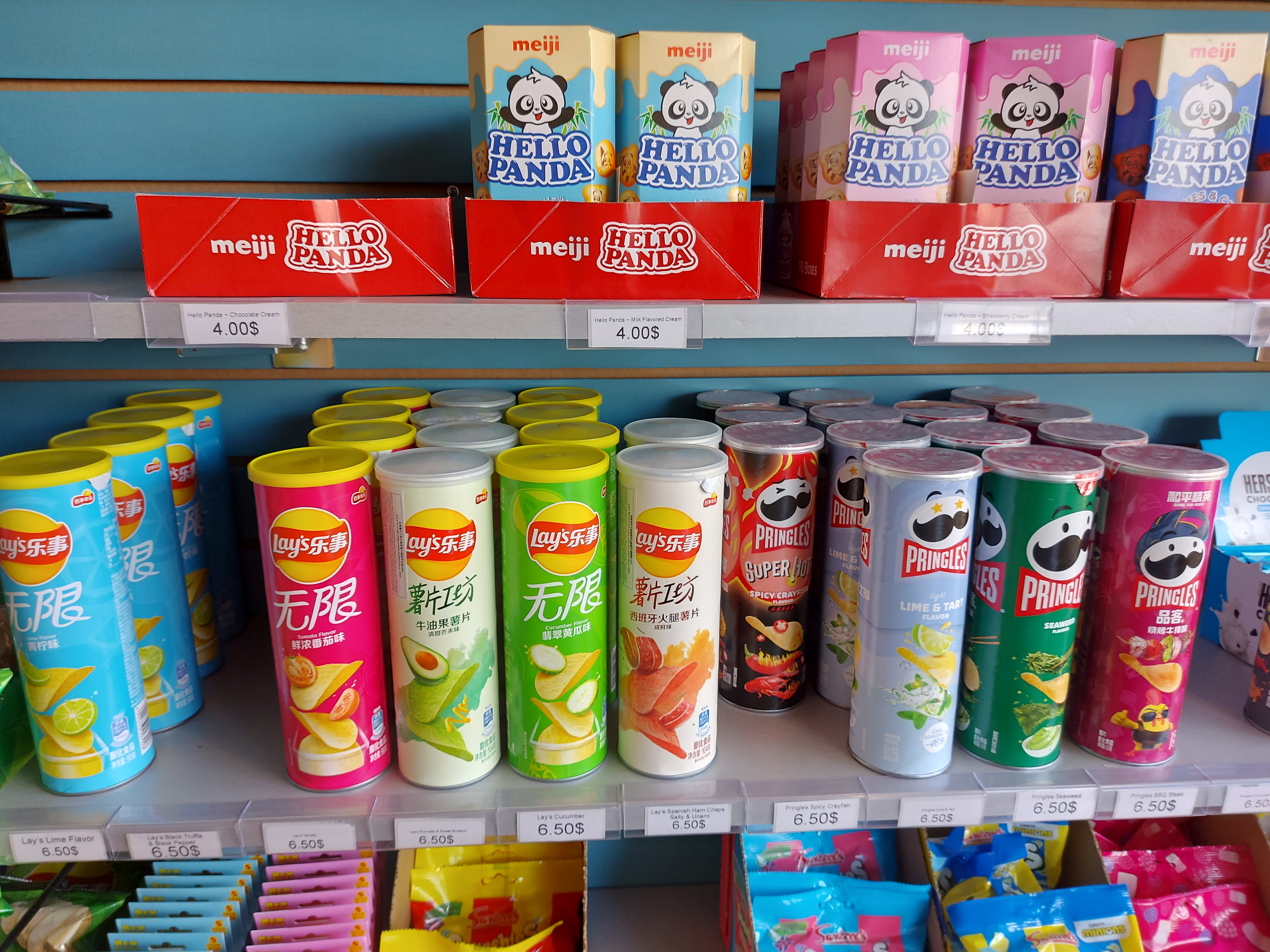 A zoom-out of all of the pringles that are sold at the Sweet Freez candy and fruit shop