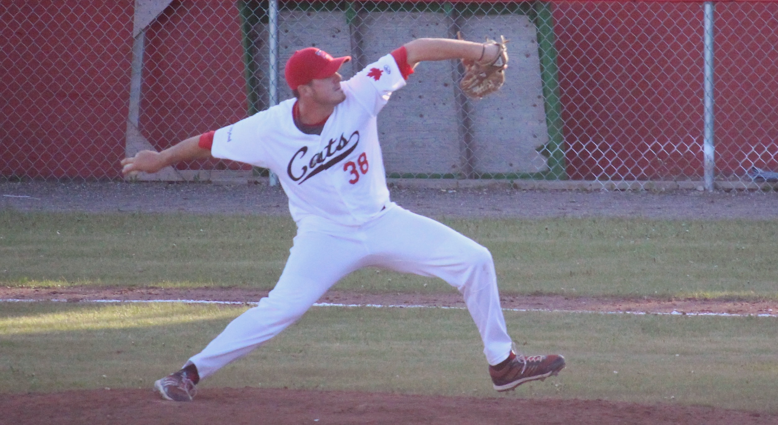 The Bordercats pitcher mid-pitch, appearing focused and smooth.