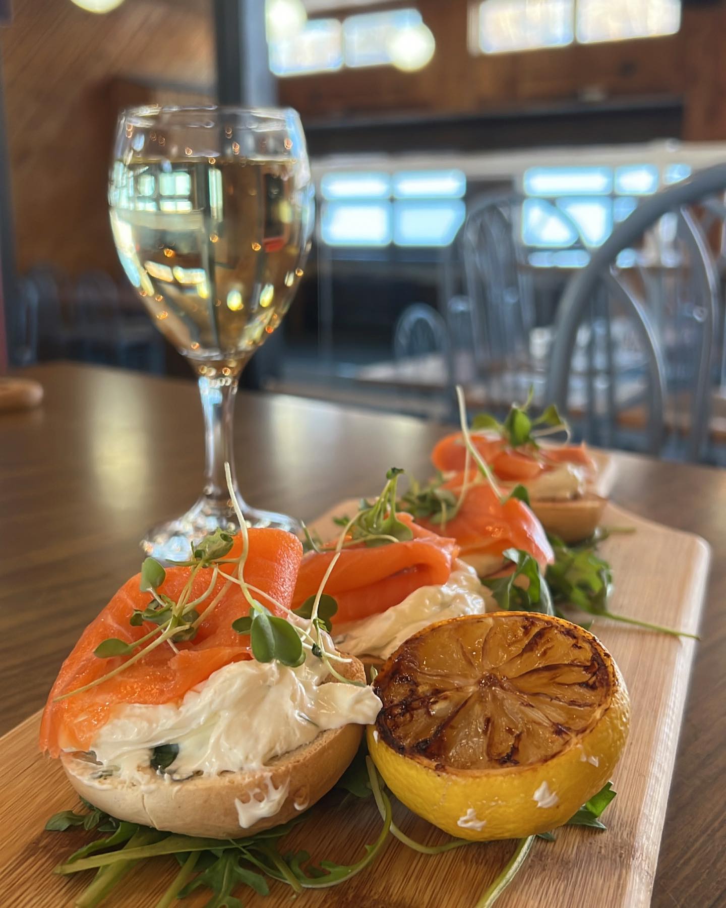 a cutting board that has some of the food that is at the Mount Jamieson Resort with a wine glass placed beside it