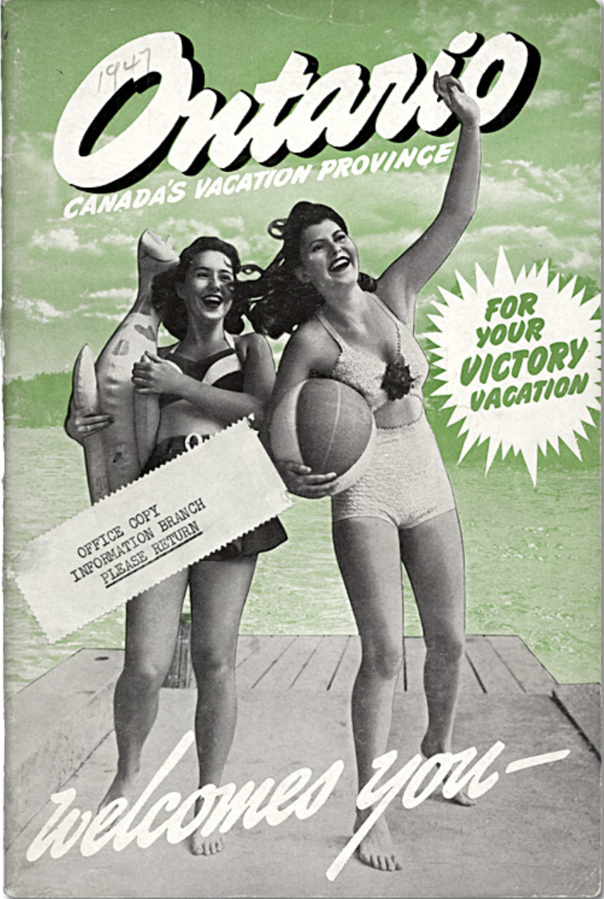 A vintage tourism ad featuring a black and white photograph of two women in 1940's bathing suits and hairstyles, smiling and waving as they hold a beachball and beach float. The background is colourized in light green and shows a lake, forest and sky spotted with fluffy clouds. White and green text reads "Ontario, Canada's Vacation Province, for your victory vacation". Written on the page in pencil is the date "1947".
