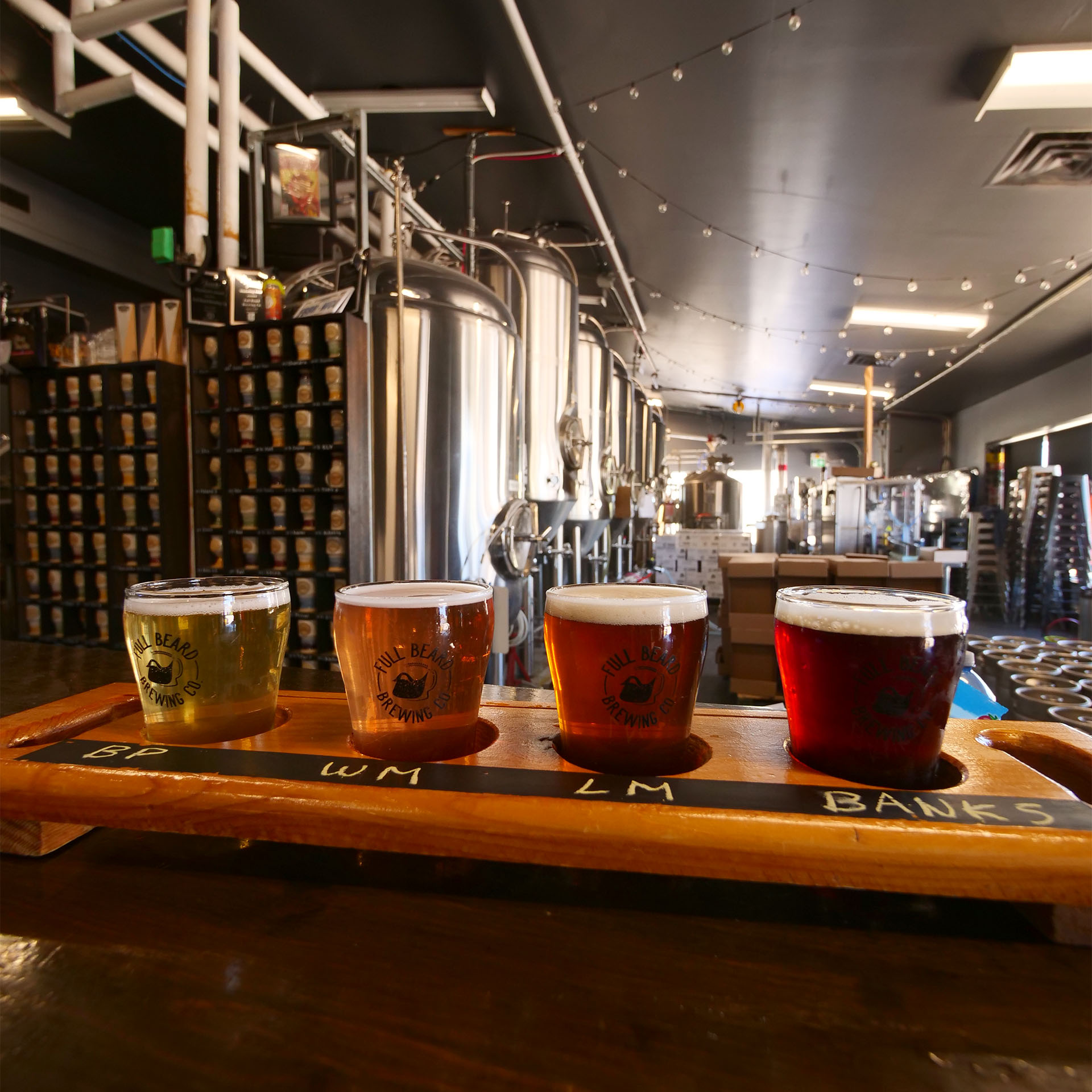 A flight of 4 differently coloured beers at Full Beard Brewing.