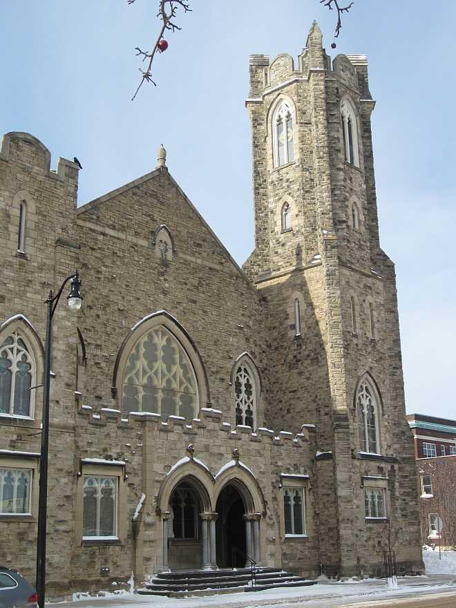 The St. Andrews Church in Thunder Bay; a large, ornate stone church in the Late Gothic Revival style with bell tower and stained glass windows.