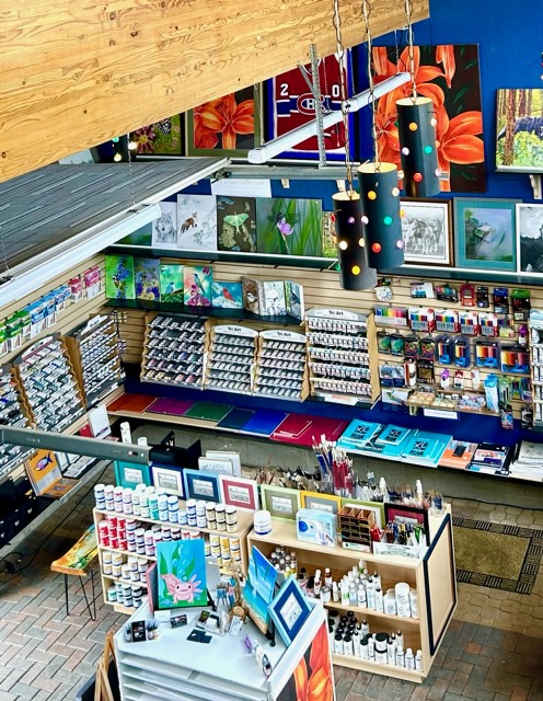 A wide view of one of the walls inside of the Artsie store filled with art supplies