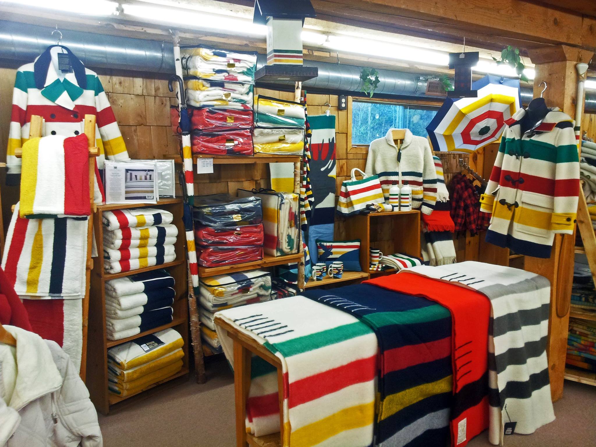 Shelves full of woolen Hudson's Bay Company blankets, scarves and coats on display in the French River Trading Post.