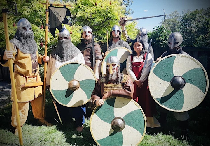 Several people dressed as vikings with round shields and chain mail helmets at the Vikingfest.