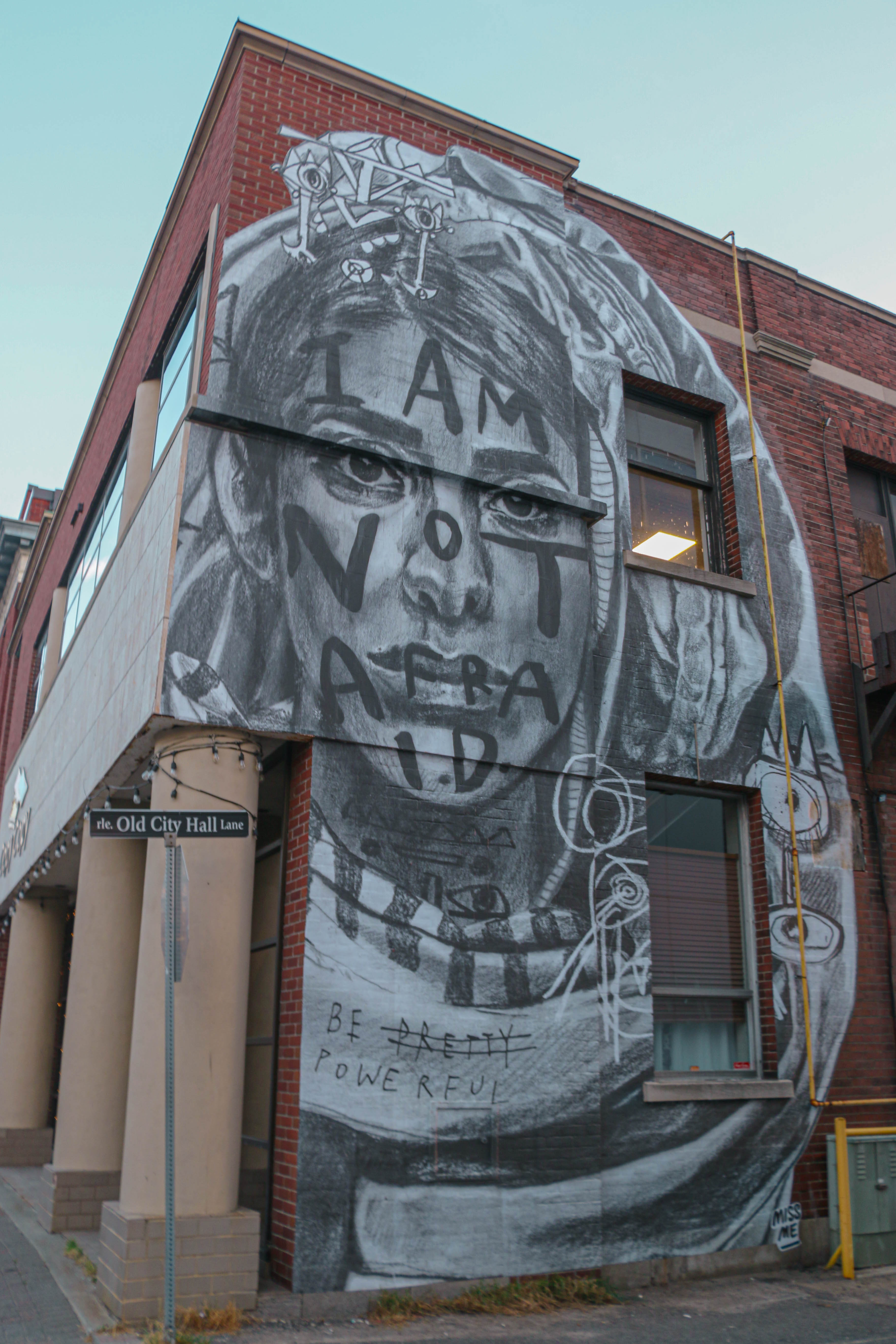 Black & white mural of a woman on side of building