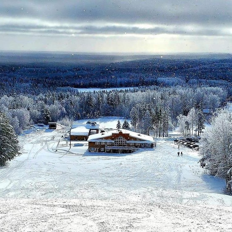 Mount Jamieson Ski Resort from the top of the ski hill, surrounded in frosty trees and silvery winter clouds.