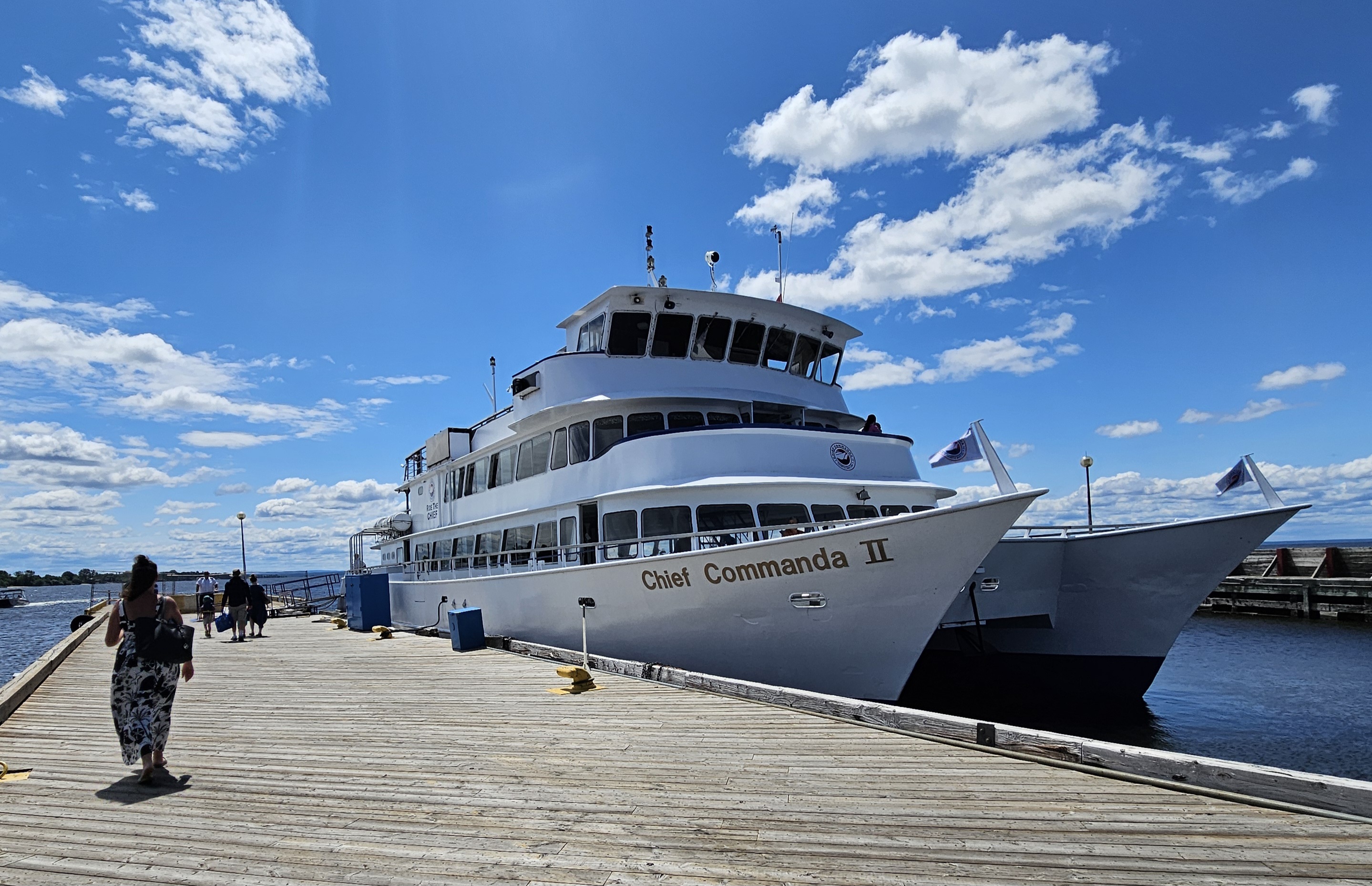 The Chief Commanda 2; a huge white lake cruise ship at port, surrounded by blue lake ane blue sky.