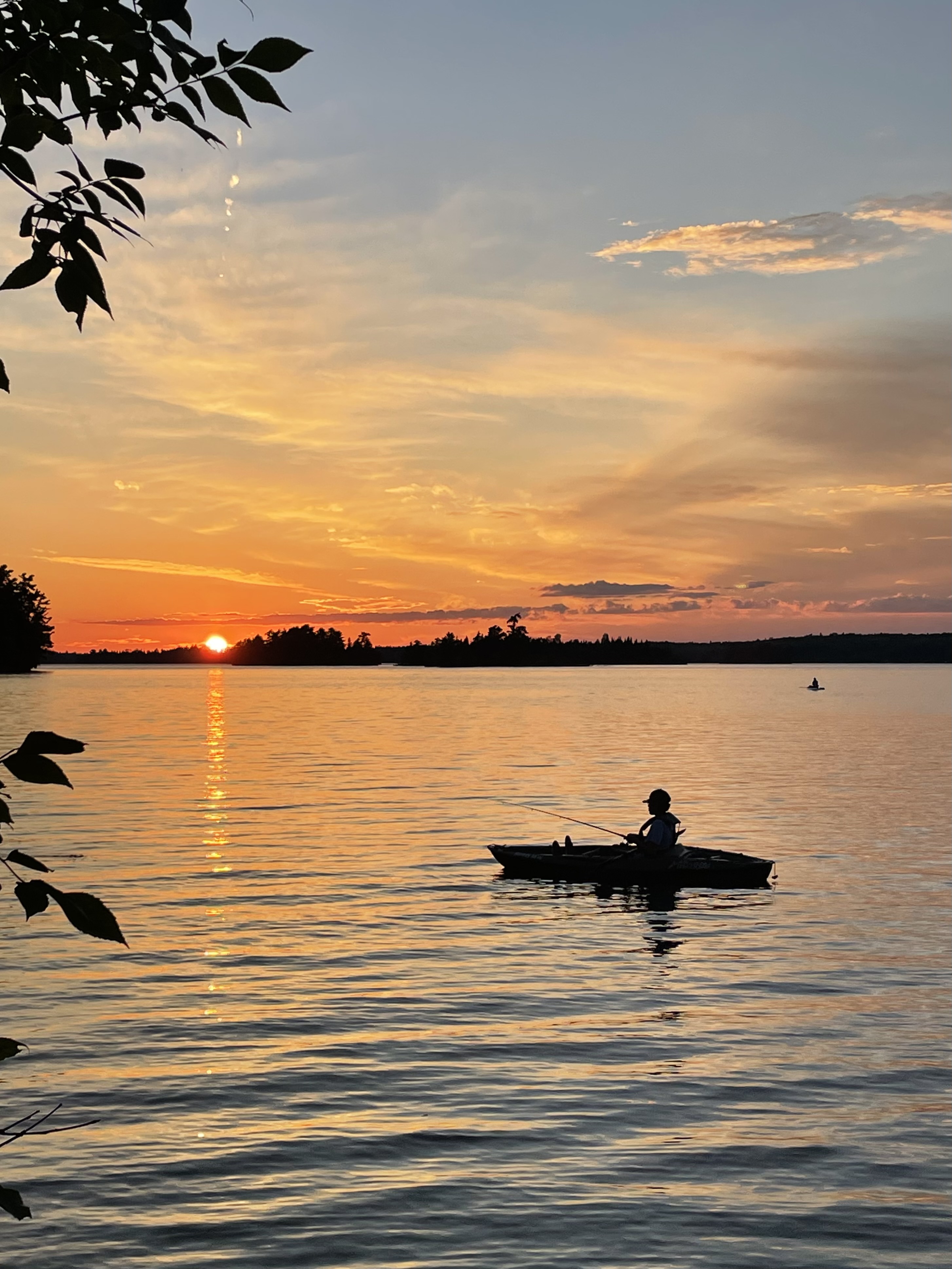 Kayaker at sunset on Lake of the Woods, Long Bay