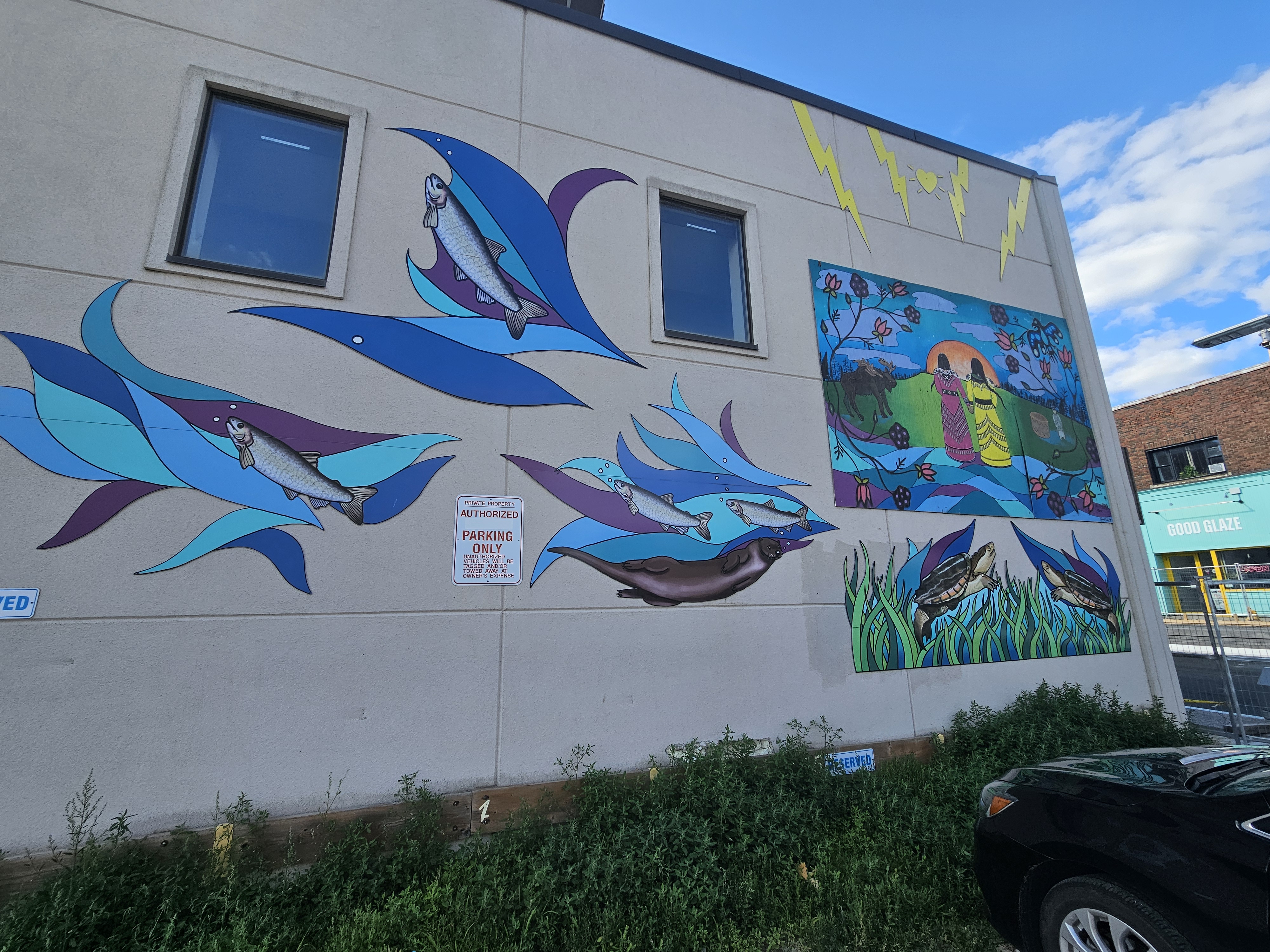 a mural on the outside of a building in North Bay, featuring a geometric blue bird motif.