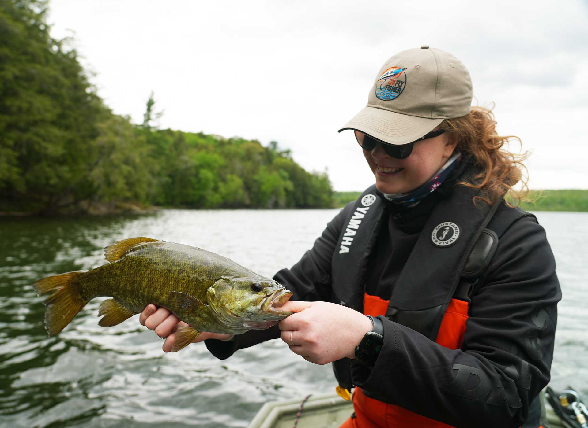 female angler holding smallmouth bass