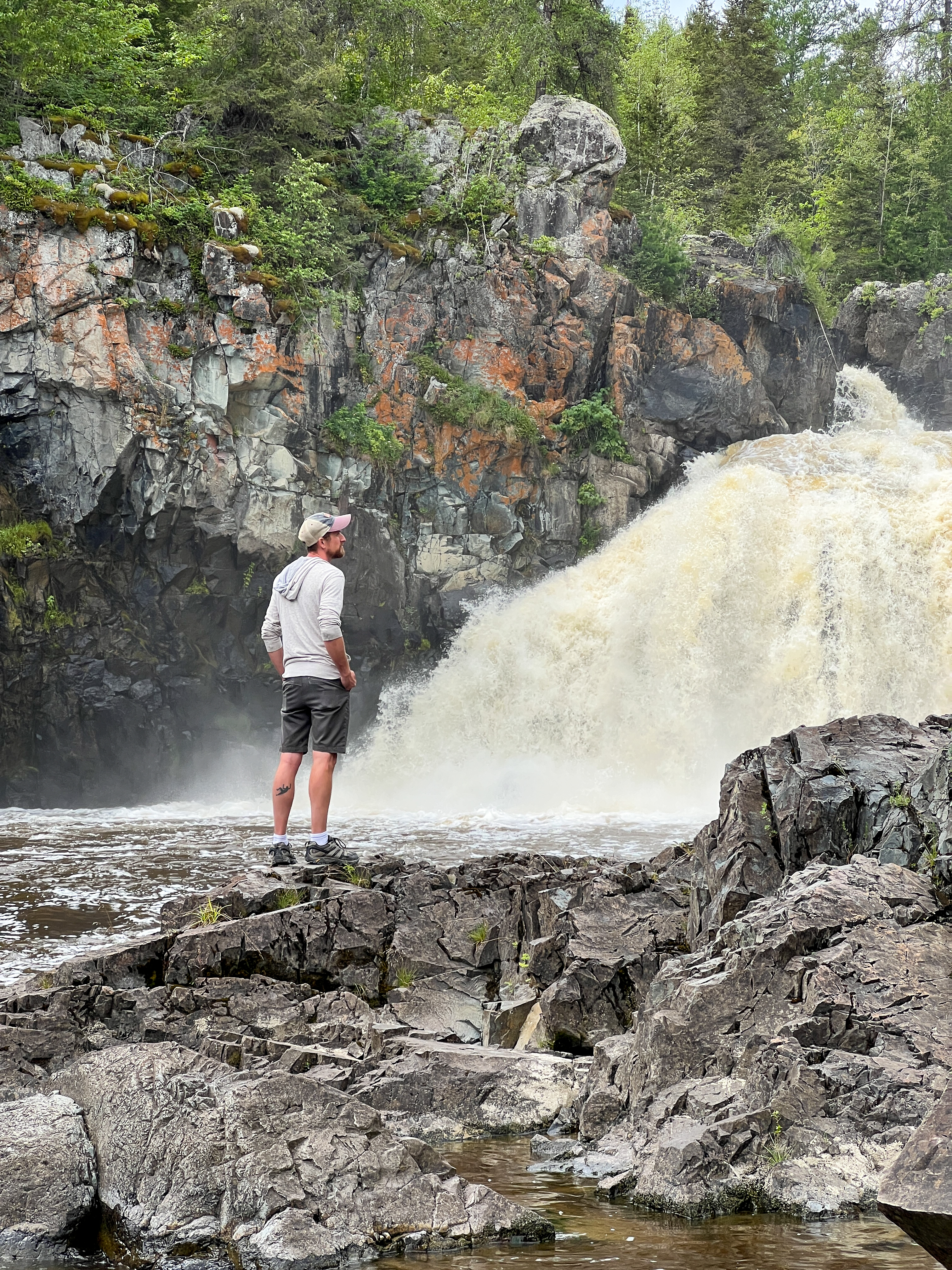 Man standing near waterfalls in Kap-Kig-Iwan provincial park 