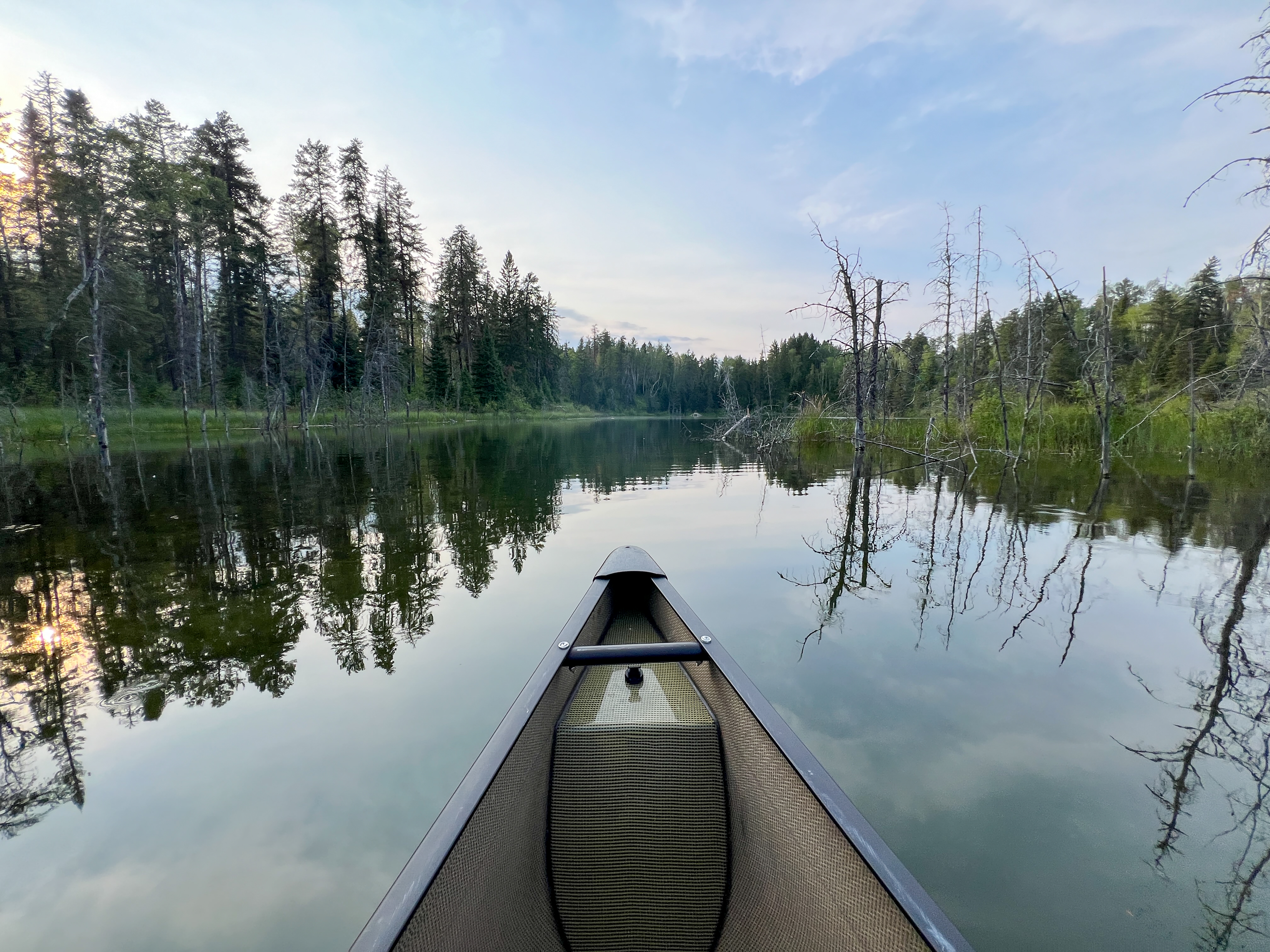 First person POV of a canoe in calm water