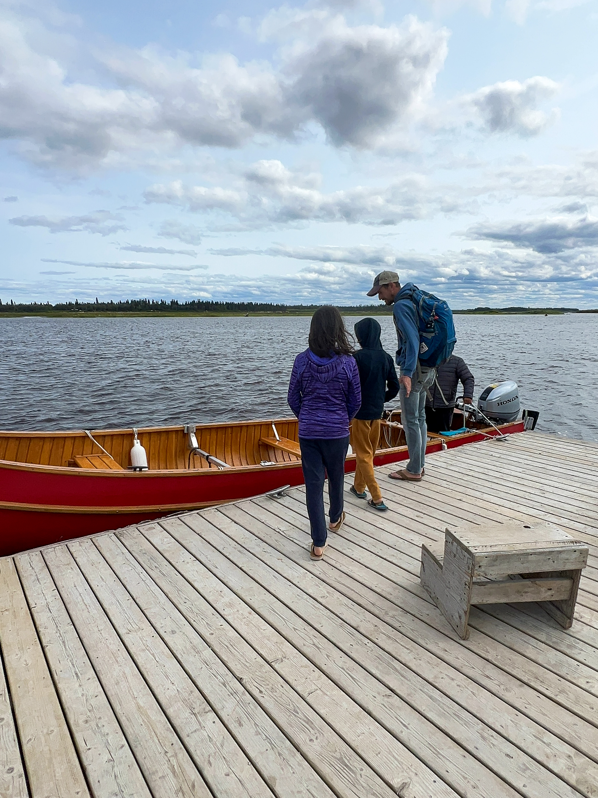 Family heading into a boat on James Bay