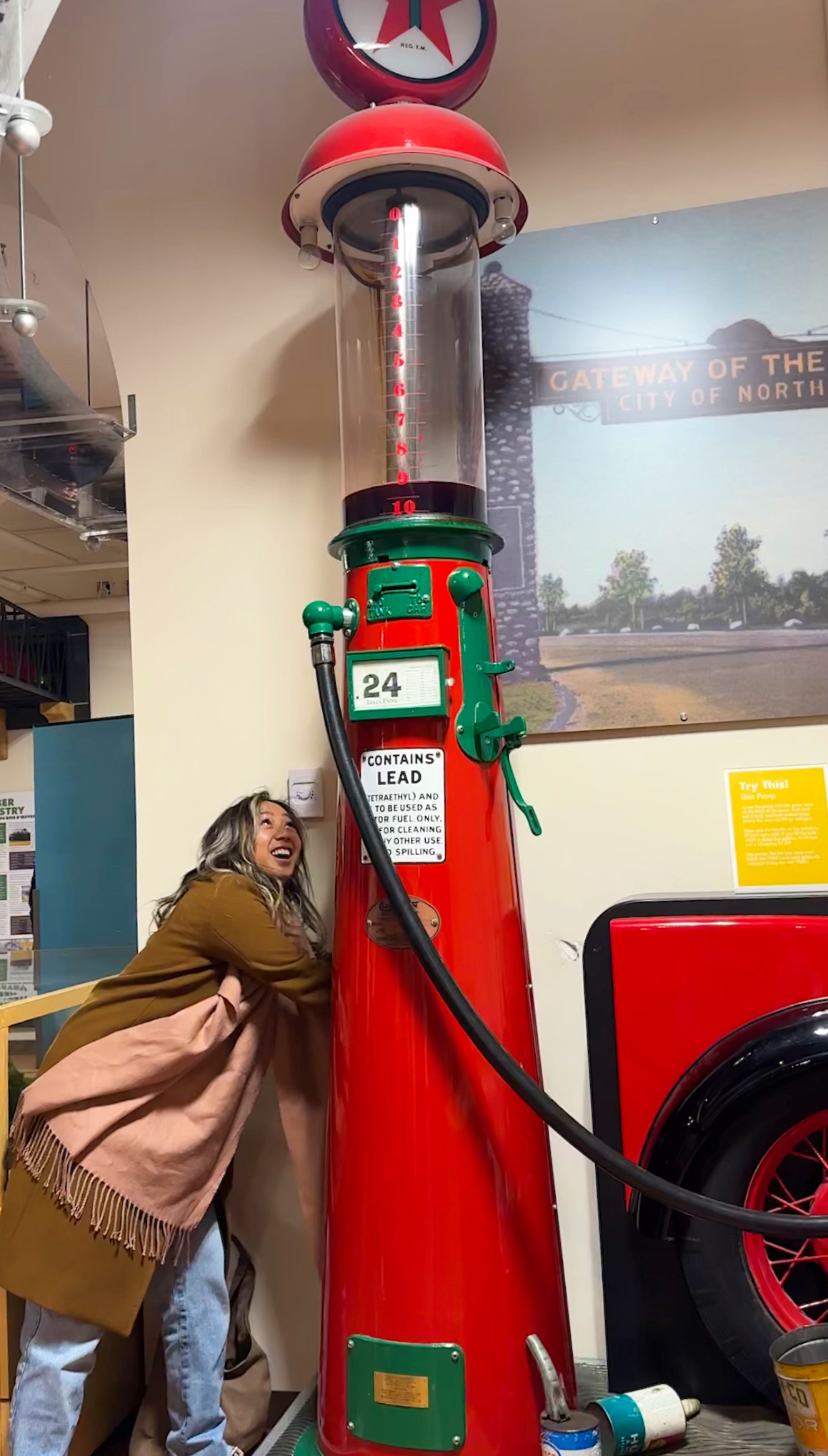 A red vintage gas pump at a museum.