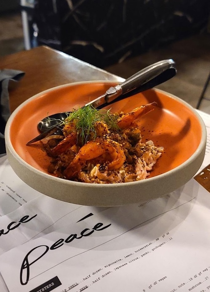 A dish of food on top of a stack of menus at Peace Restaurant in Sault Ste. Marie.