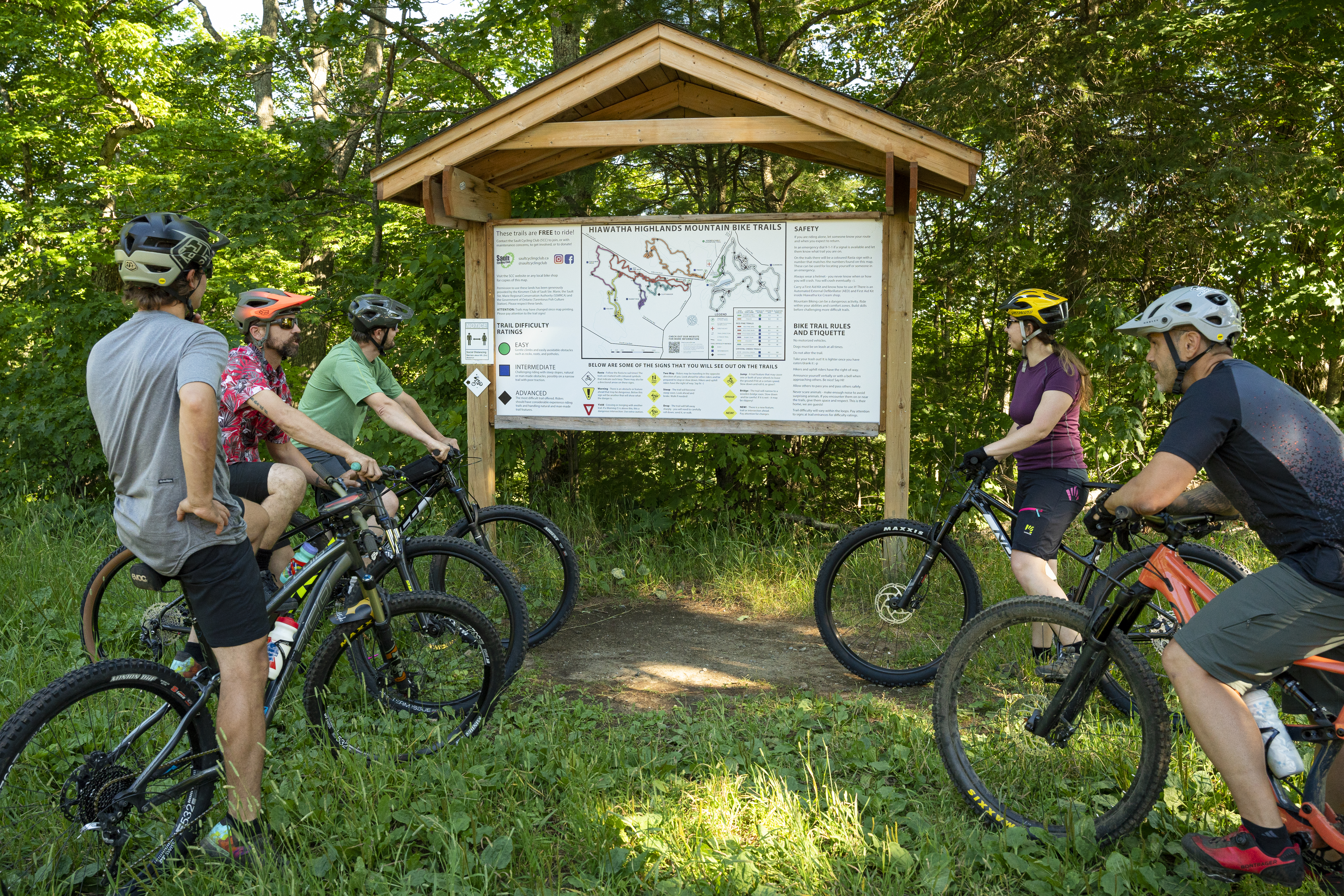 cyclists look at a trail map