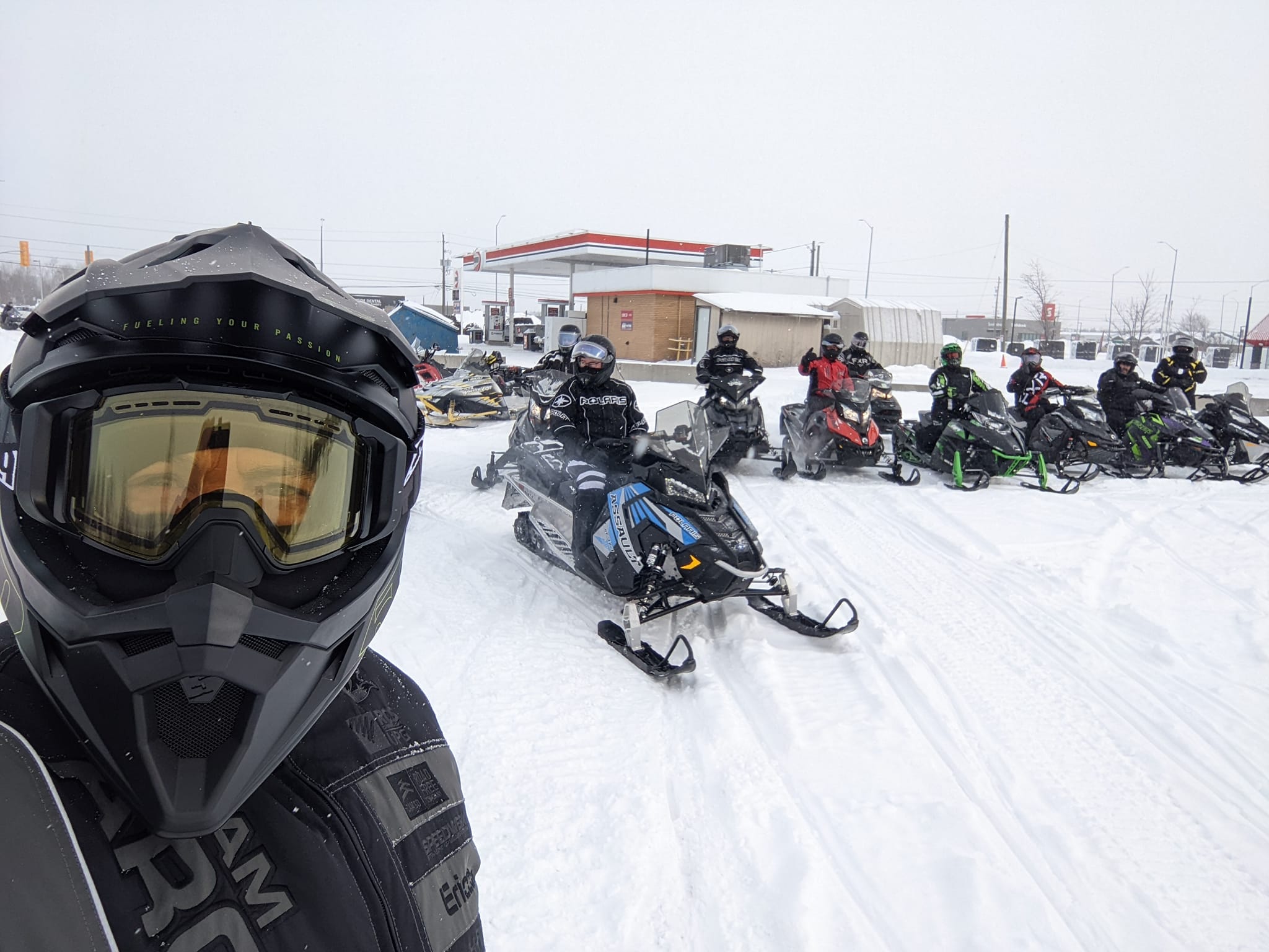 Poker run people snowmobiling. 