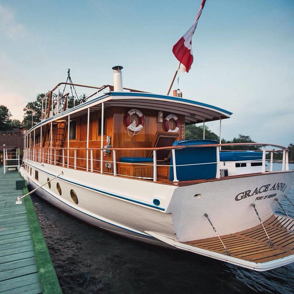 The luxurious Grace Anne II cruise boat sits at dock under a blue sky. 